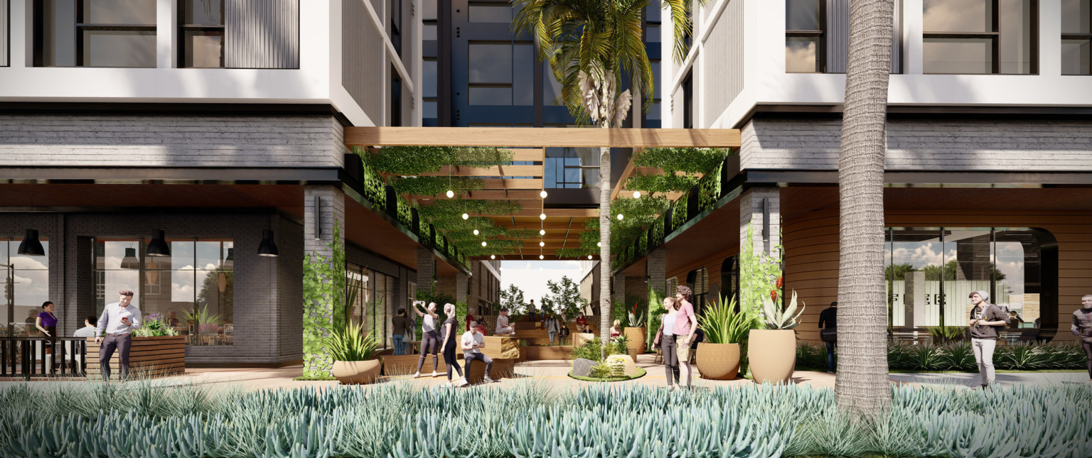 Entrance to mixed-use facility with greenery on canopy in recessed space between tiled buildings. White wrap facade