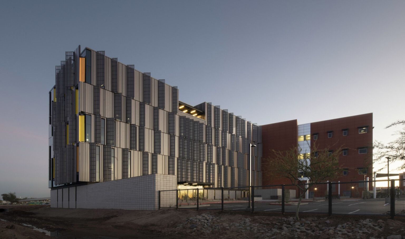 Dusk shot of Pinal County Attorney’s Offices, a serrated wrapped facade in alternating horizontal layers