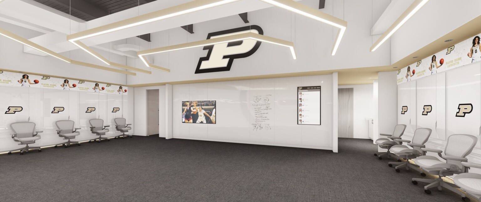 Double height white locker room with full length white board wall opposite, Purdue logo. Concentric squared arch shaped pendant lights hanging