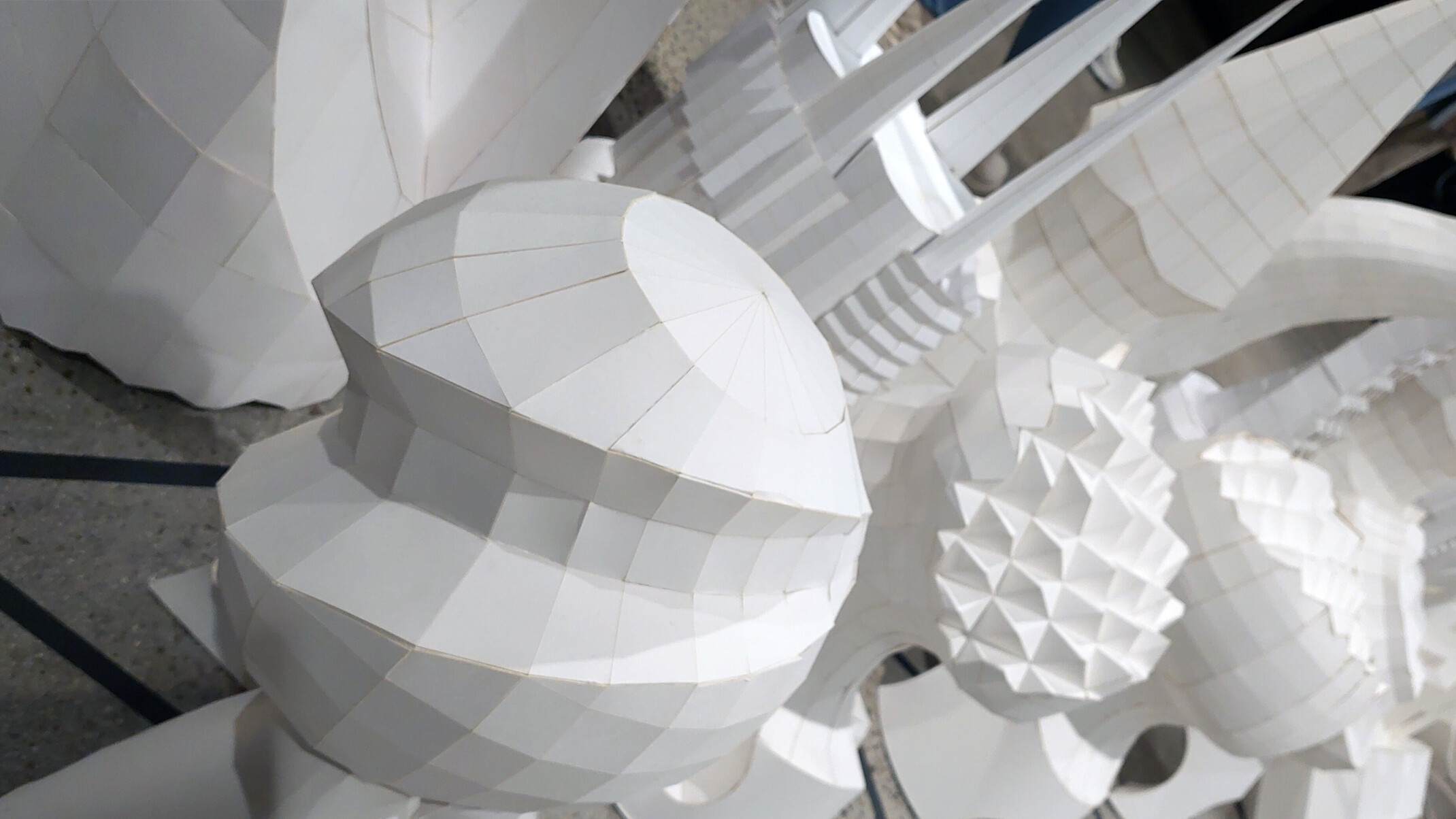 complex white shapes, spires, spheres, abstract geometries, folded grid, origami, modern art