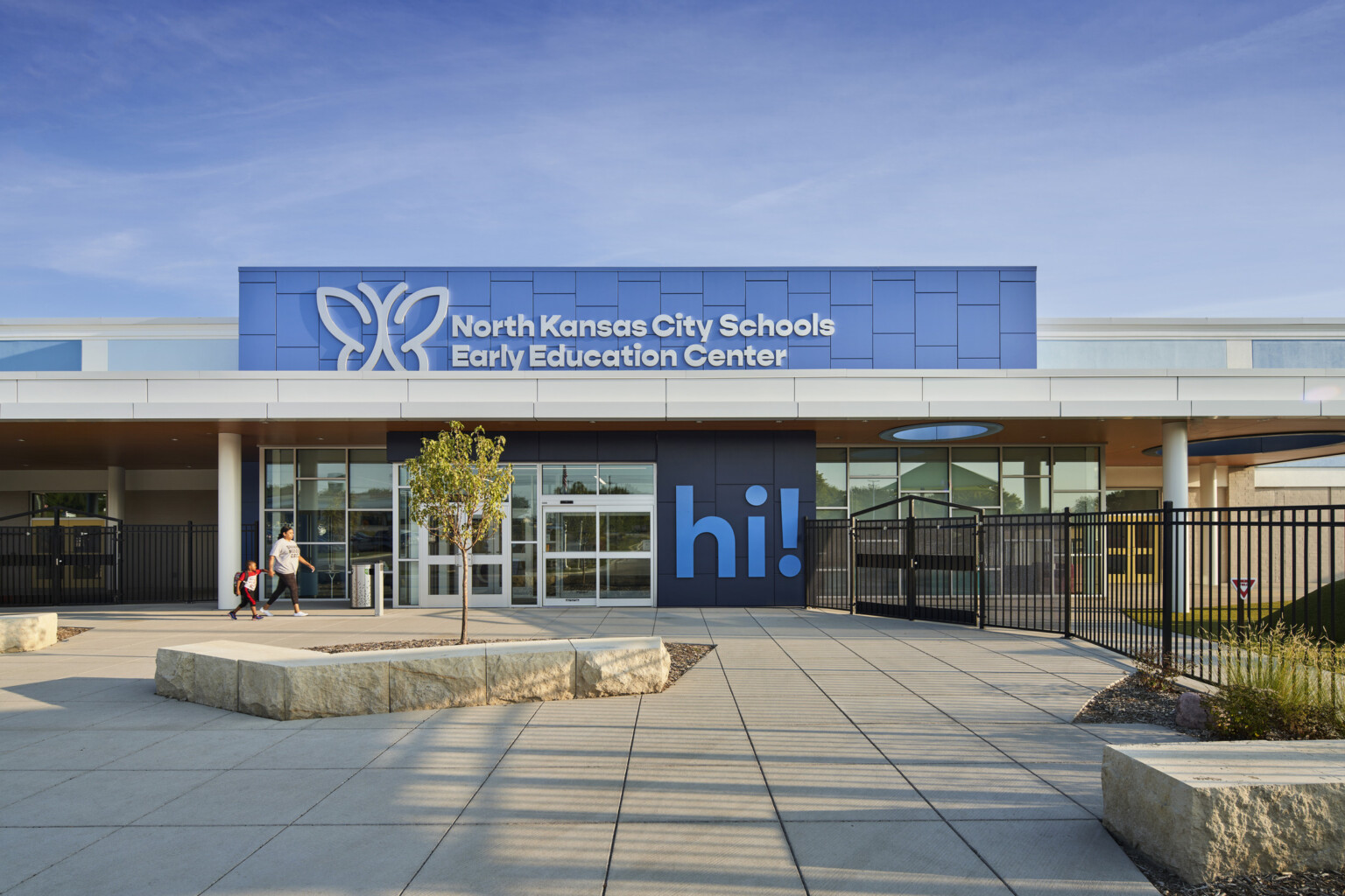 North Kansas City School Early Education Center exterior, a two tone blue facade, large "Hi!" mural by entry