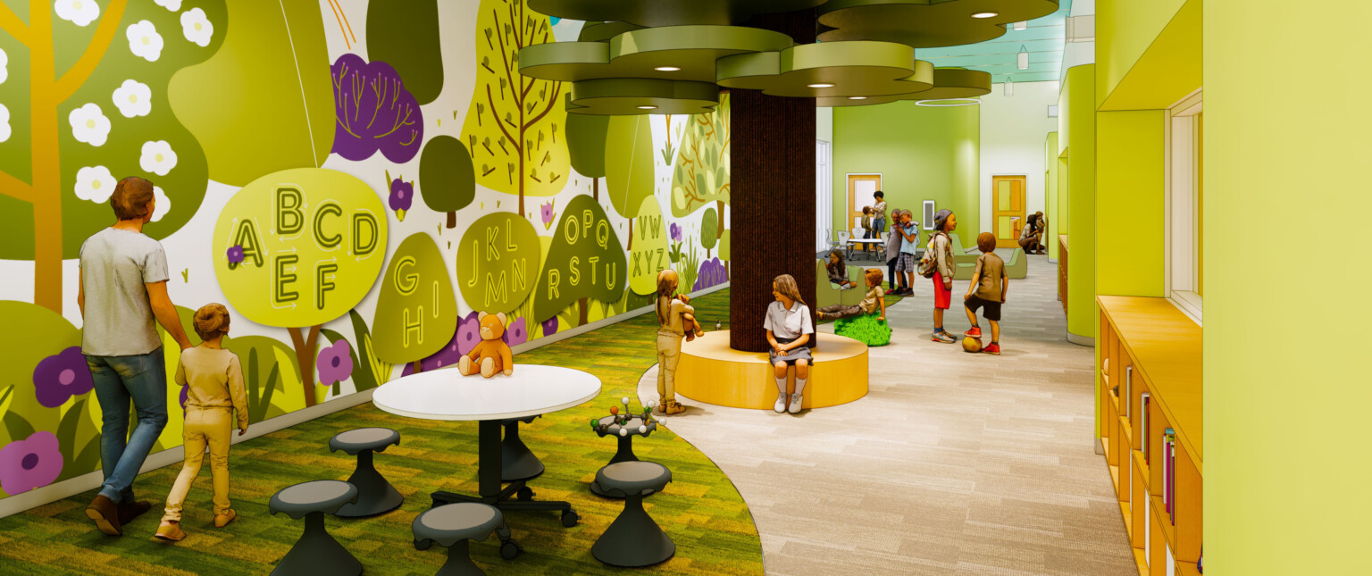 Green hallway, alphabet on left wall in forest mural. Fake cartoonish tree in double height hallway, curved mutlicolor carpet