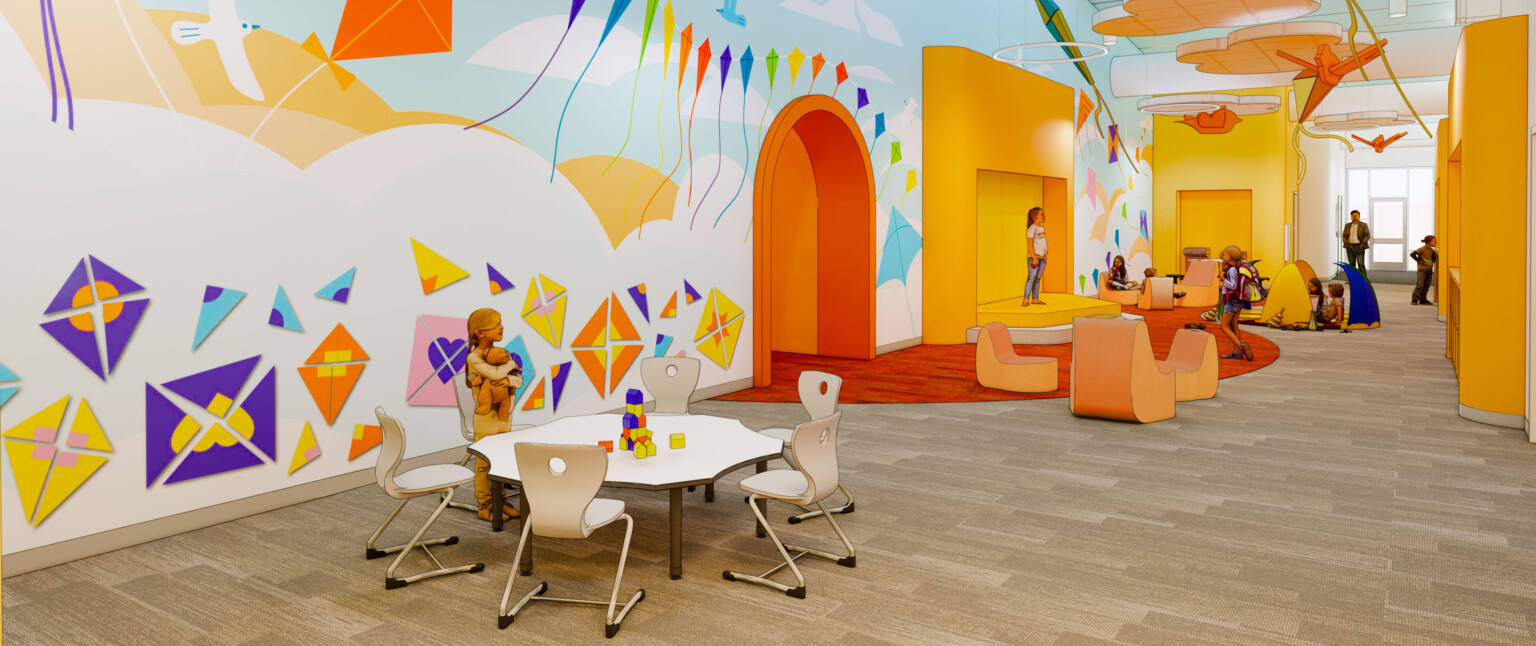 Kite mural on left wall in hallway with orange accents, small stages, comfortable flexible furniture. Double height ceiling