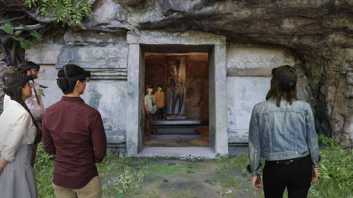People using virtual realty VR headset at entry of Revealing Krishna exhibit, stone facade of ancient cave temple reproduction People using virtual realty VR headset at entry of Revealing Krishna exhibit, stone facade of ancient cave temple reproduction