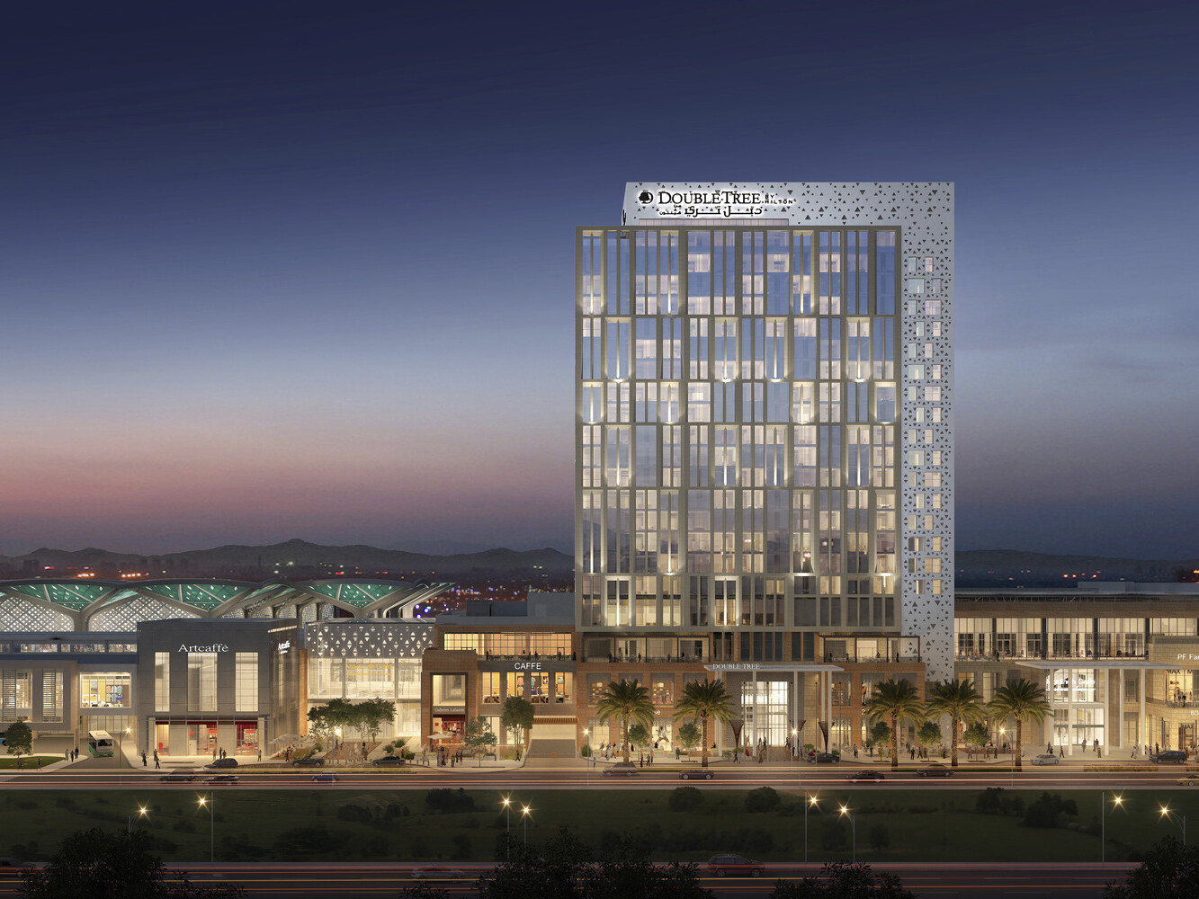 3 story building seen from across parking lot, Double Tree hotel rising above at center. Multiple entrances and large windows