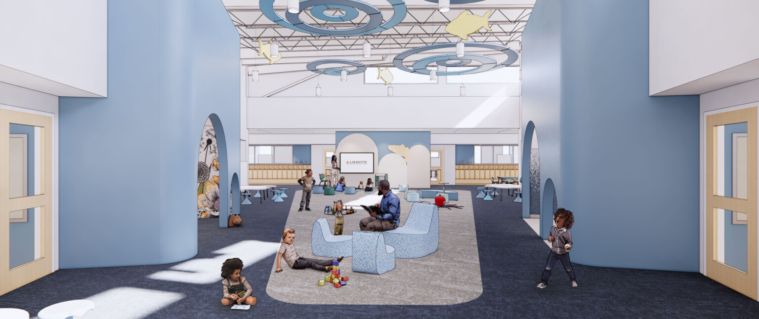 Blue walls and furniture in common space play area, concentric circles hang above with yellow fish. Clerestory windows above