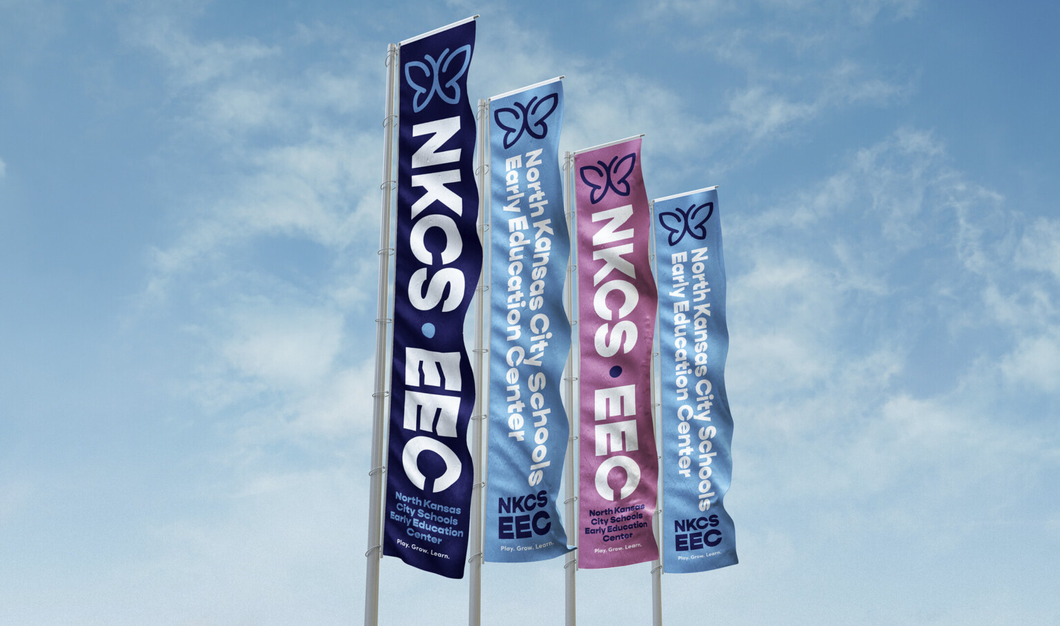 blue and purple vertical banners with white lettering against a blue sky