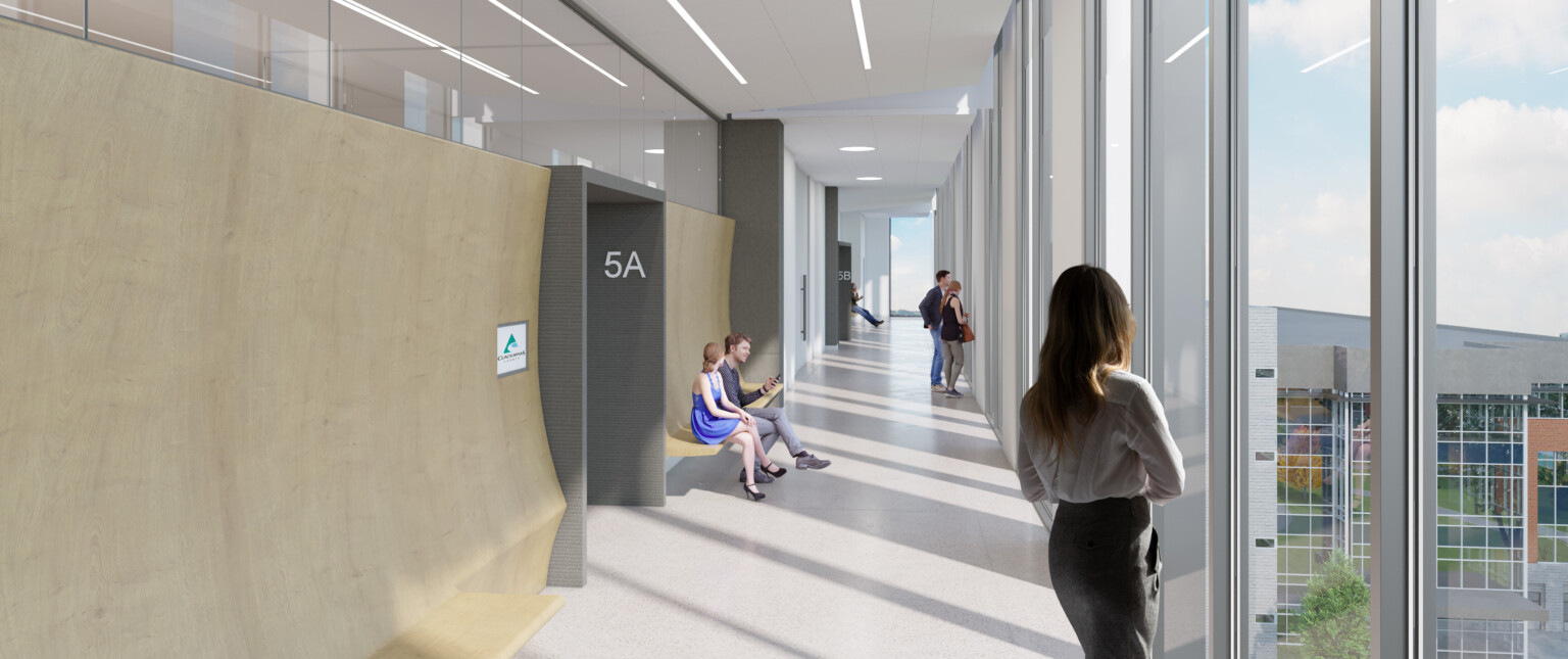 Daylit hallway with floor to ceiling windows, white design features, and light wood walls with access into courtrooms