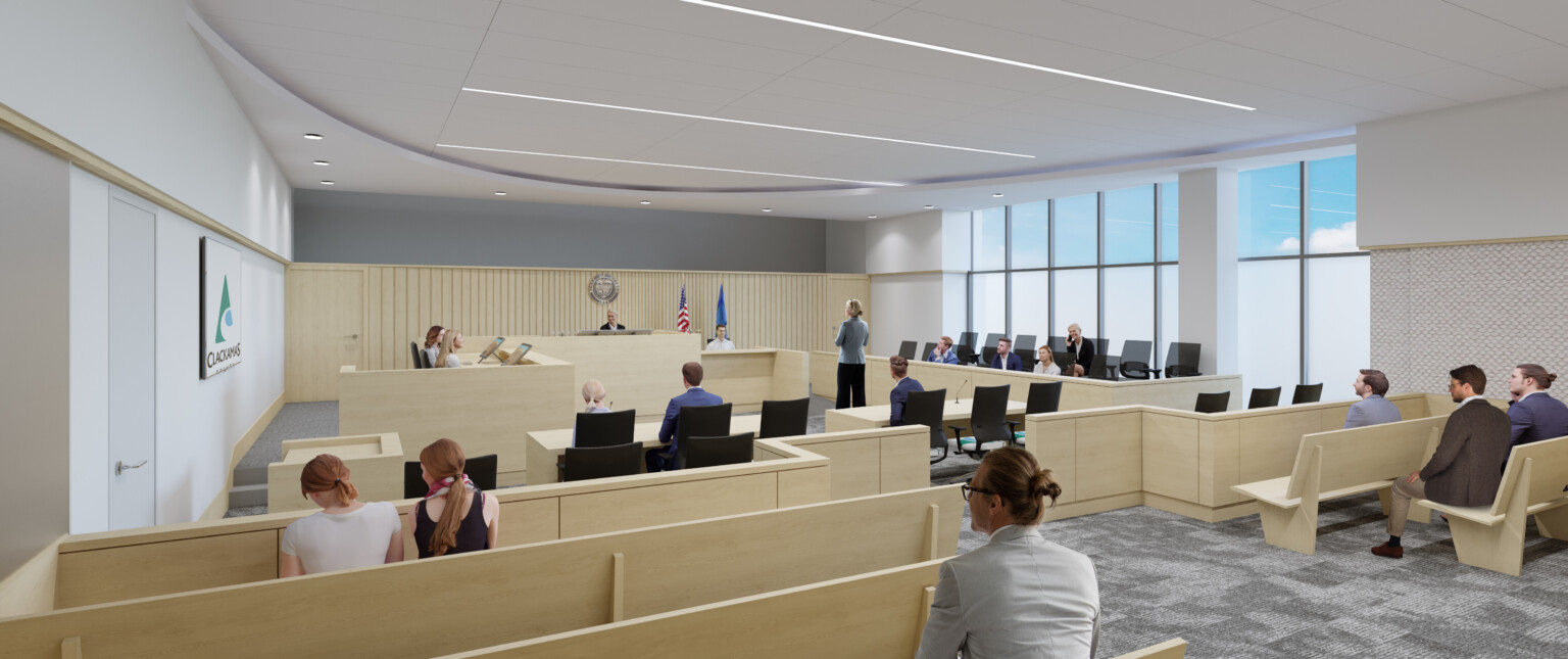 Bright courtroom filled with natural daylight, light wood bench seating in rows face judge and jury seating