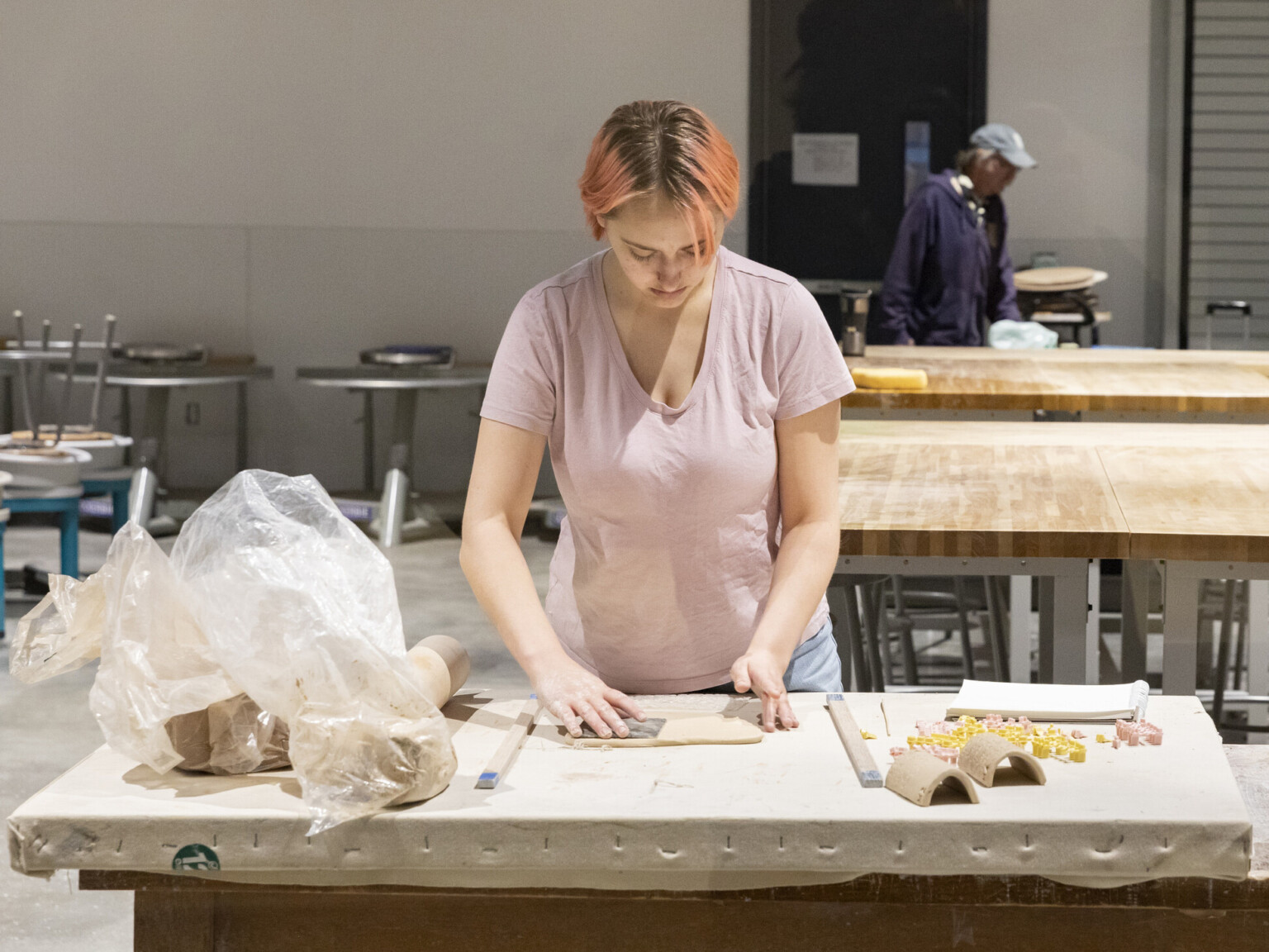 Woman creating clay sculptures in one of two ceramic studios at Allan Hancock Fine Arts Complex