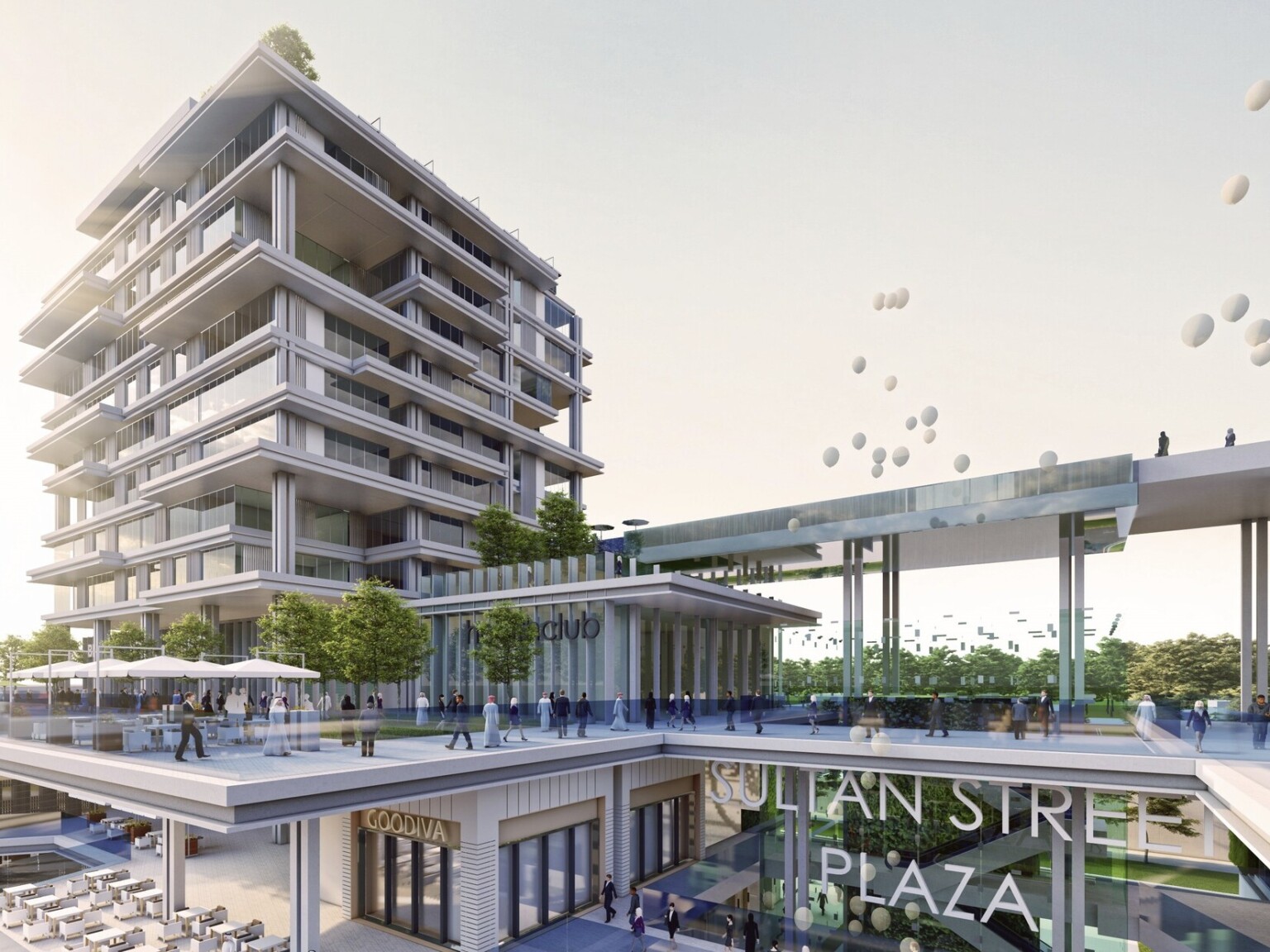 Entrance of Sultan Street Plaza with outdoor dining in front of 3 floor shopping center and floor to ceiling window apartment