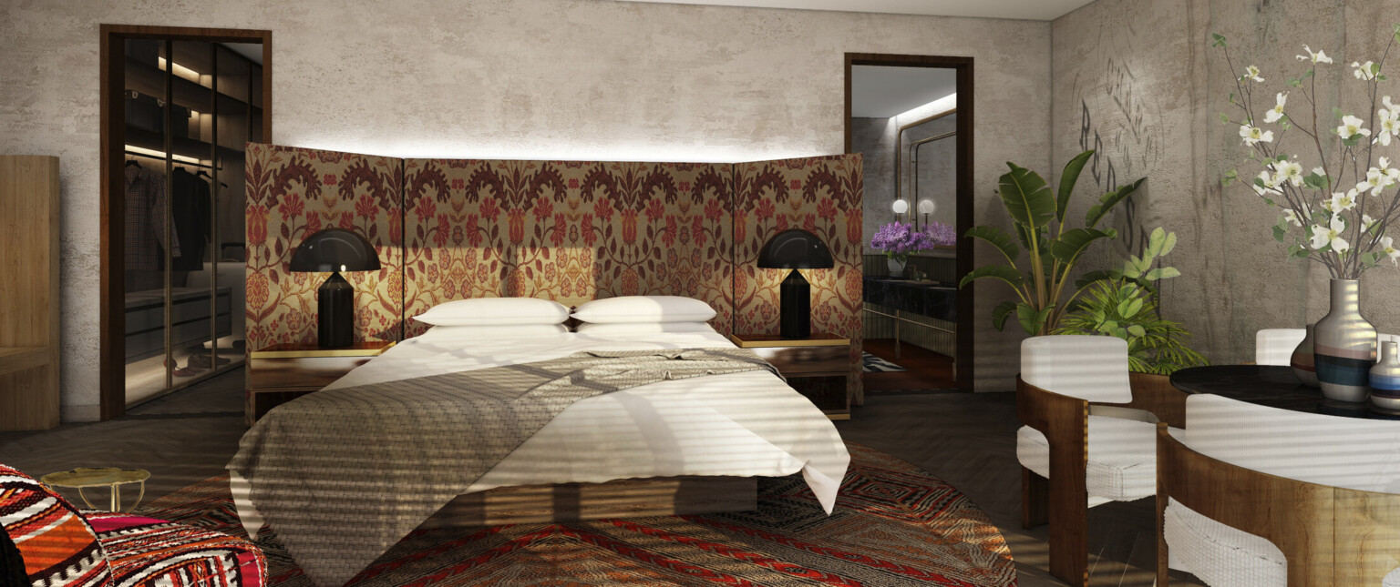 Moody hotel interior with reds, oranges, and creams, patterned fabric headboard, black lamps, textured red carpet, walk-in closet, coffered ceiling