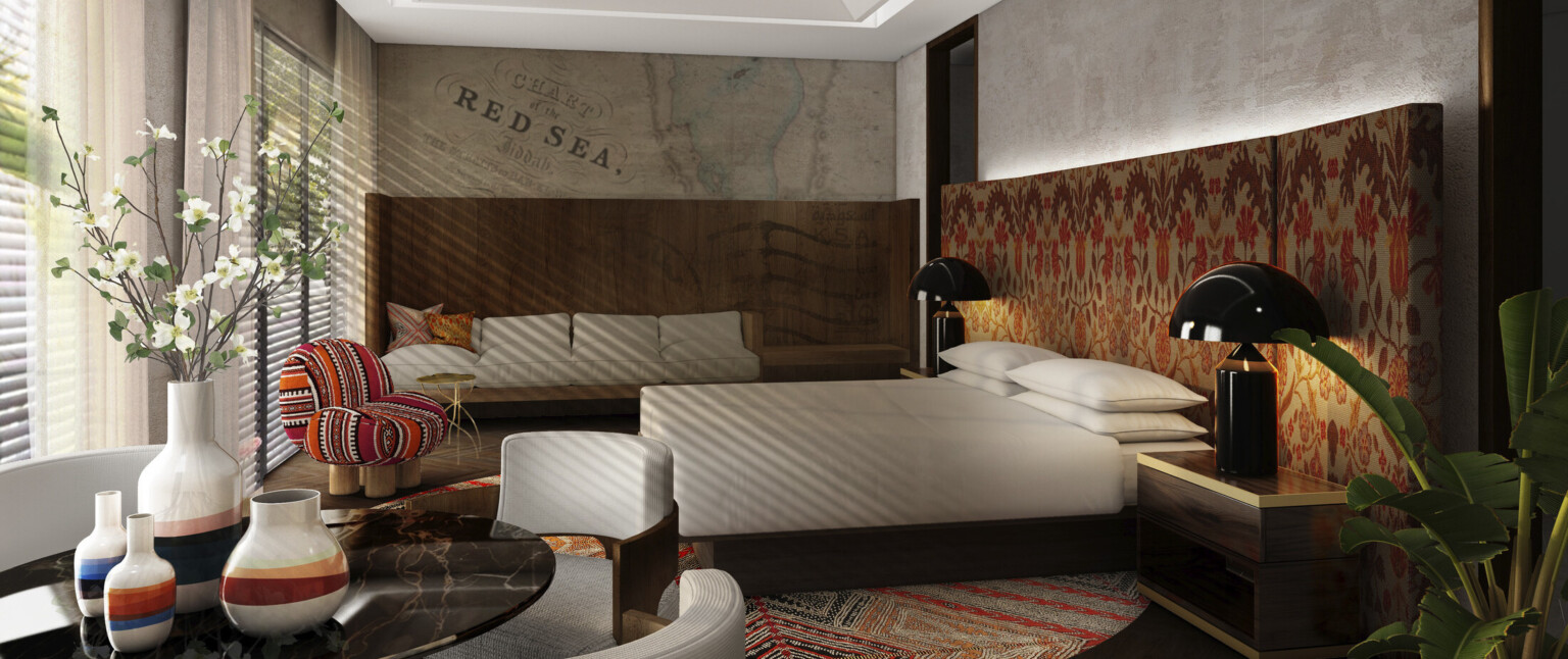 Hotel suite with white bedding, red patterned headboard, fabric textures throughout, dining table with ceramic vases and flowers, coffered ceiling