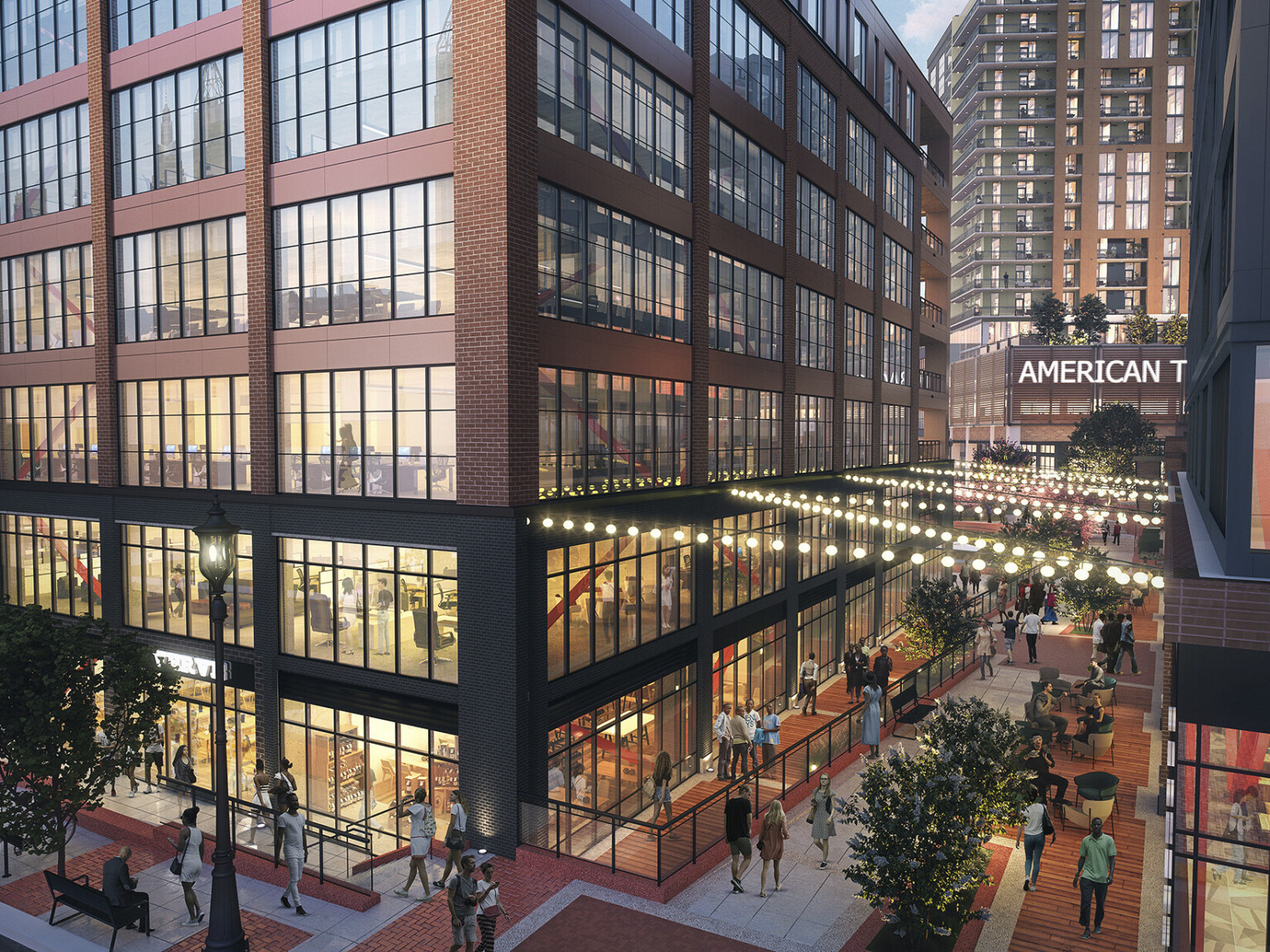 partially covered pedestrian walkway with string lights between timber office buildings with large plate glass windows