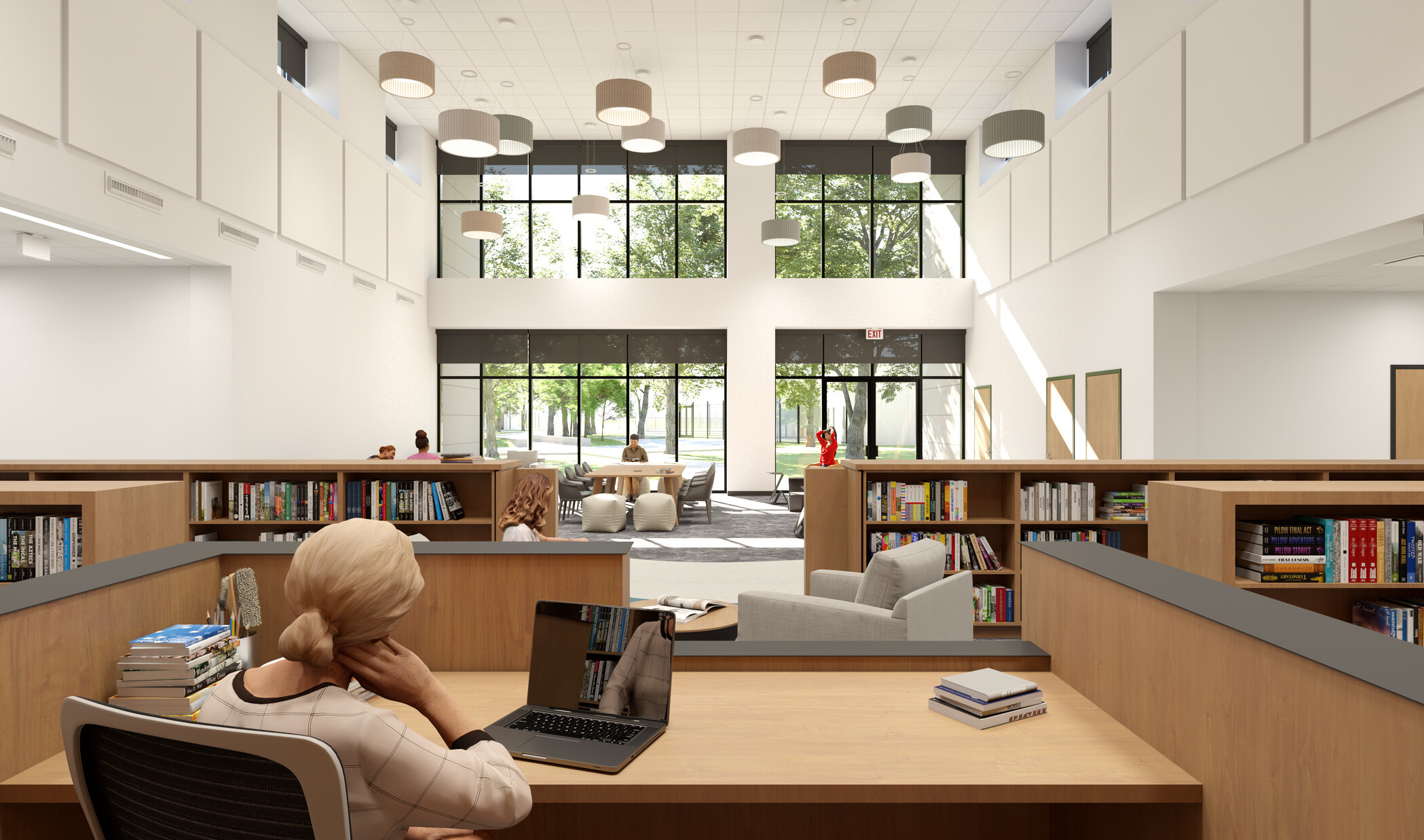 Rendering of woman working on laptop at a desk in a double-height library. Across the room, soft chairs are grouped in front of a window wall.