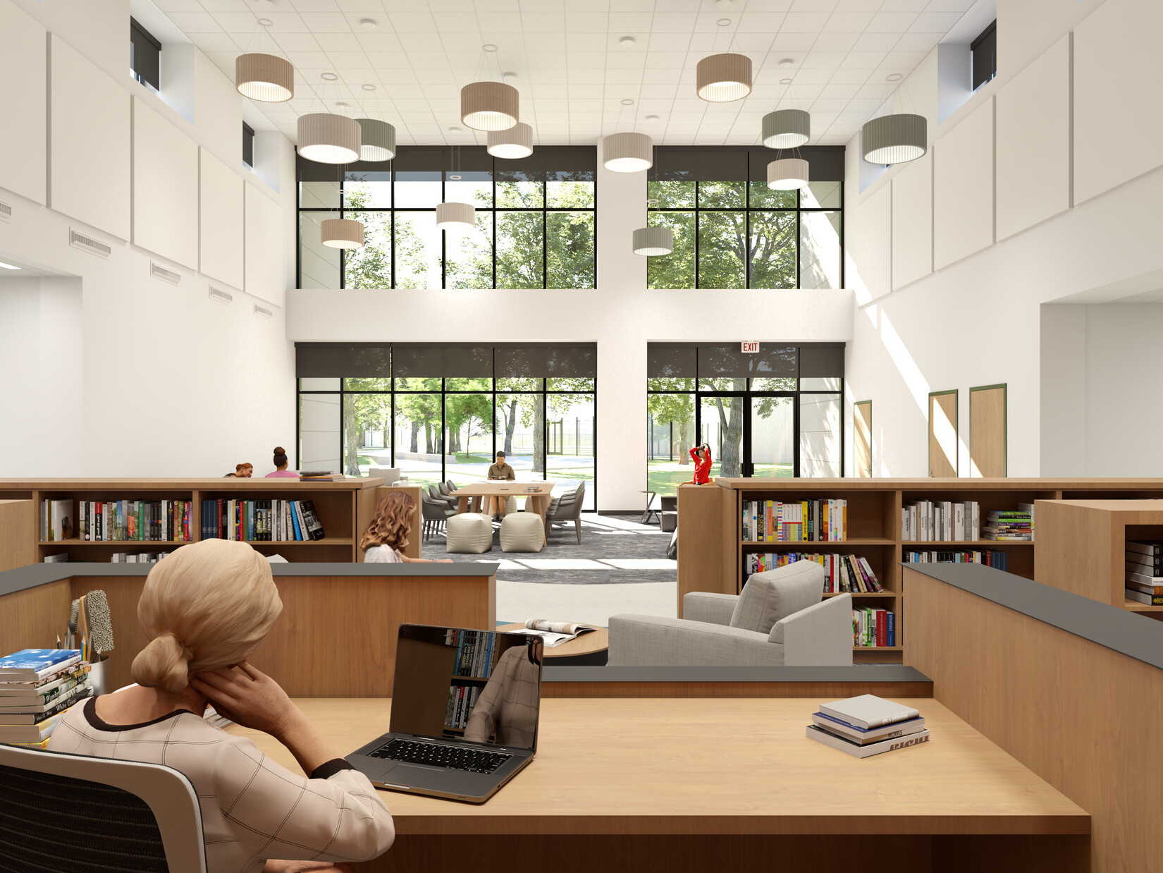 Rendering of woman working on laptop at a desk in a double-height library. Across the room, soft chairs are grouped in front of a window wall.