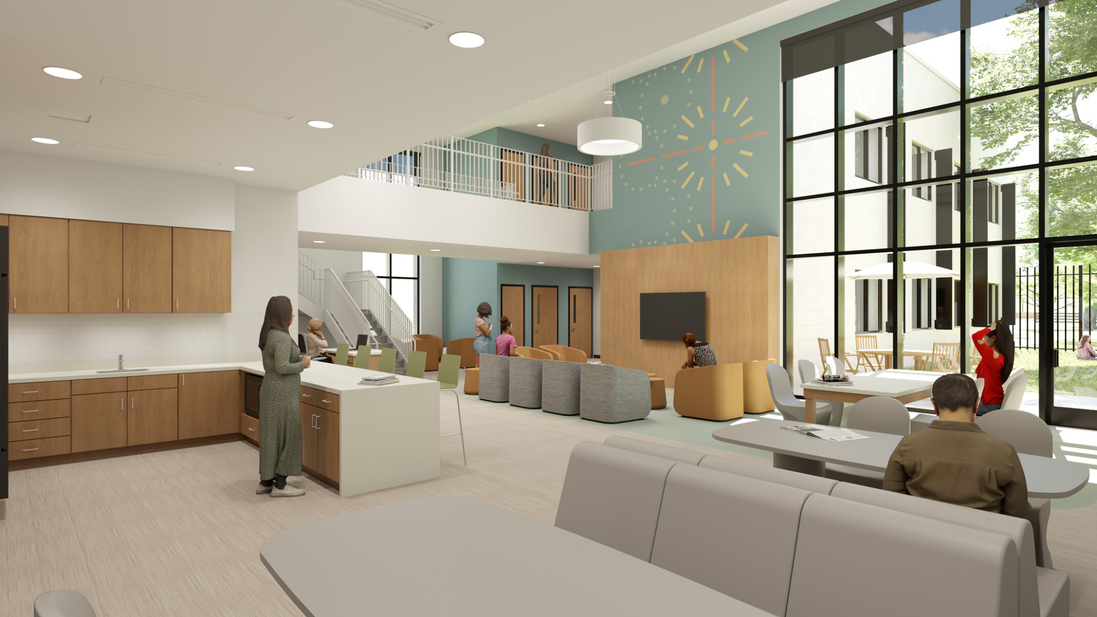 Rendering of a community living space with single-height kitchen on the left opening into a double-height room with library tables and soft seating groups. A window wall on the right looks out onto a secure courtyard with grass and a picnic table.