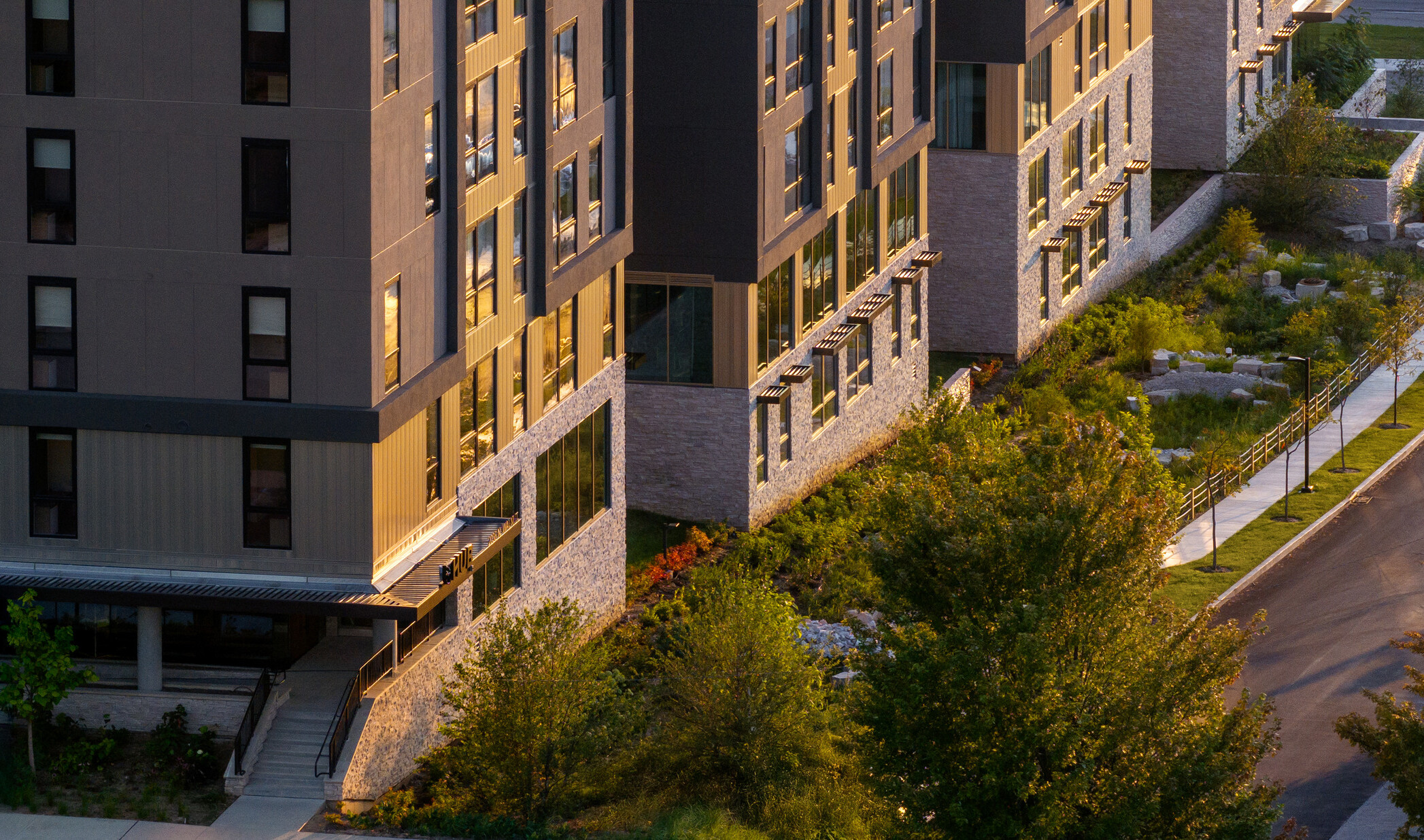 Hub Bloomington off campus student housing; Aerial view of stormwater swales and landscaped perimeter along the building.