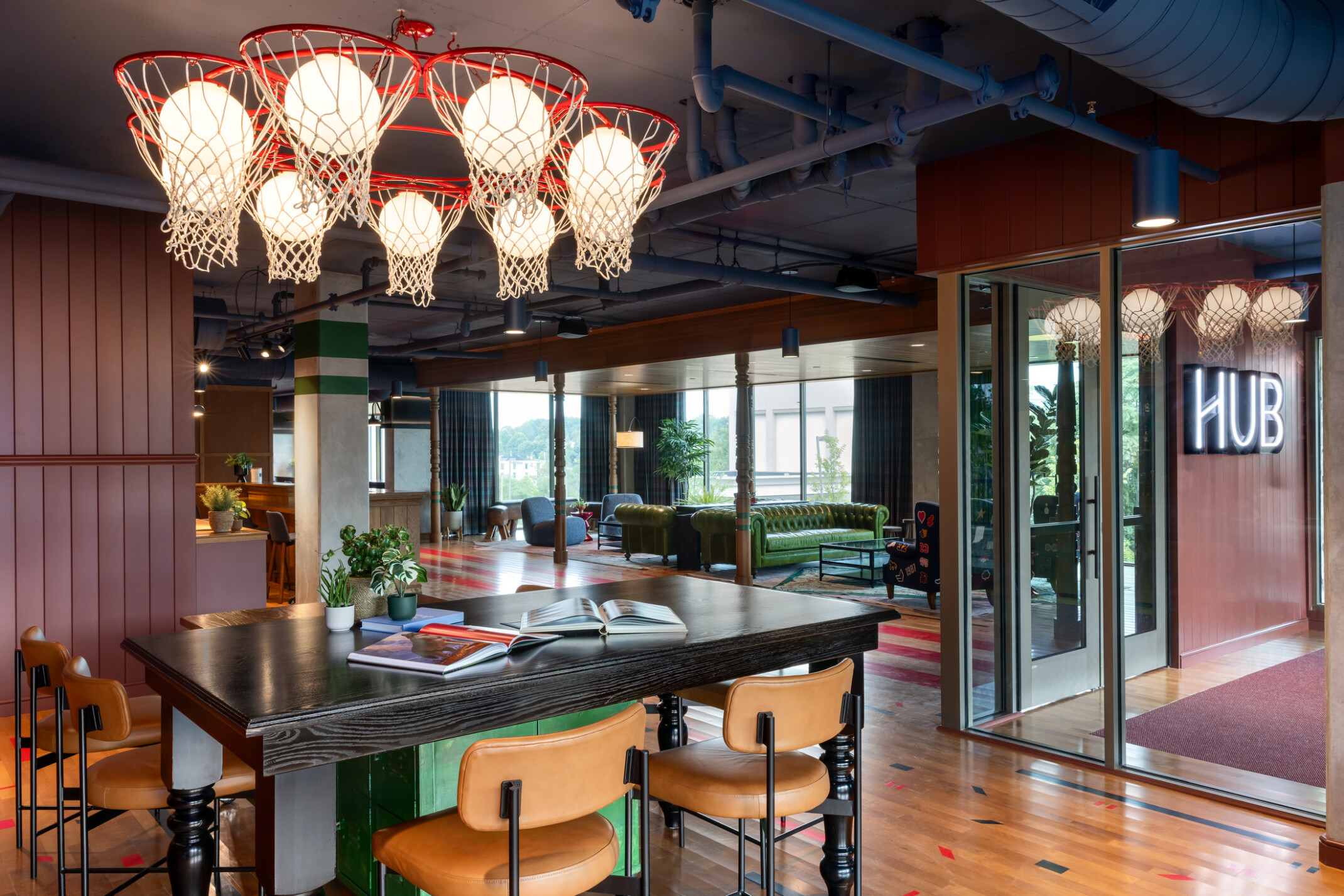 Hub Bloomington off campus student housing; Academic Hub entry showing multi-level desks and lounge seating beyond.