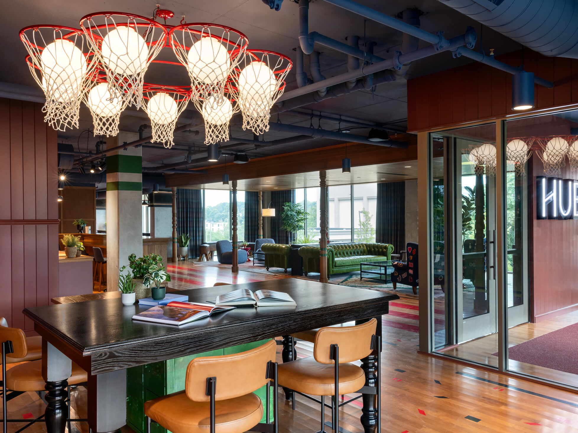 Hub Bloomington off campus student housing; Academic Hub entry showing multi-level desks and lounge seating beyond.