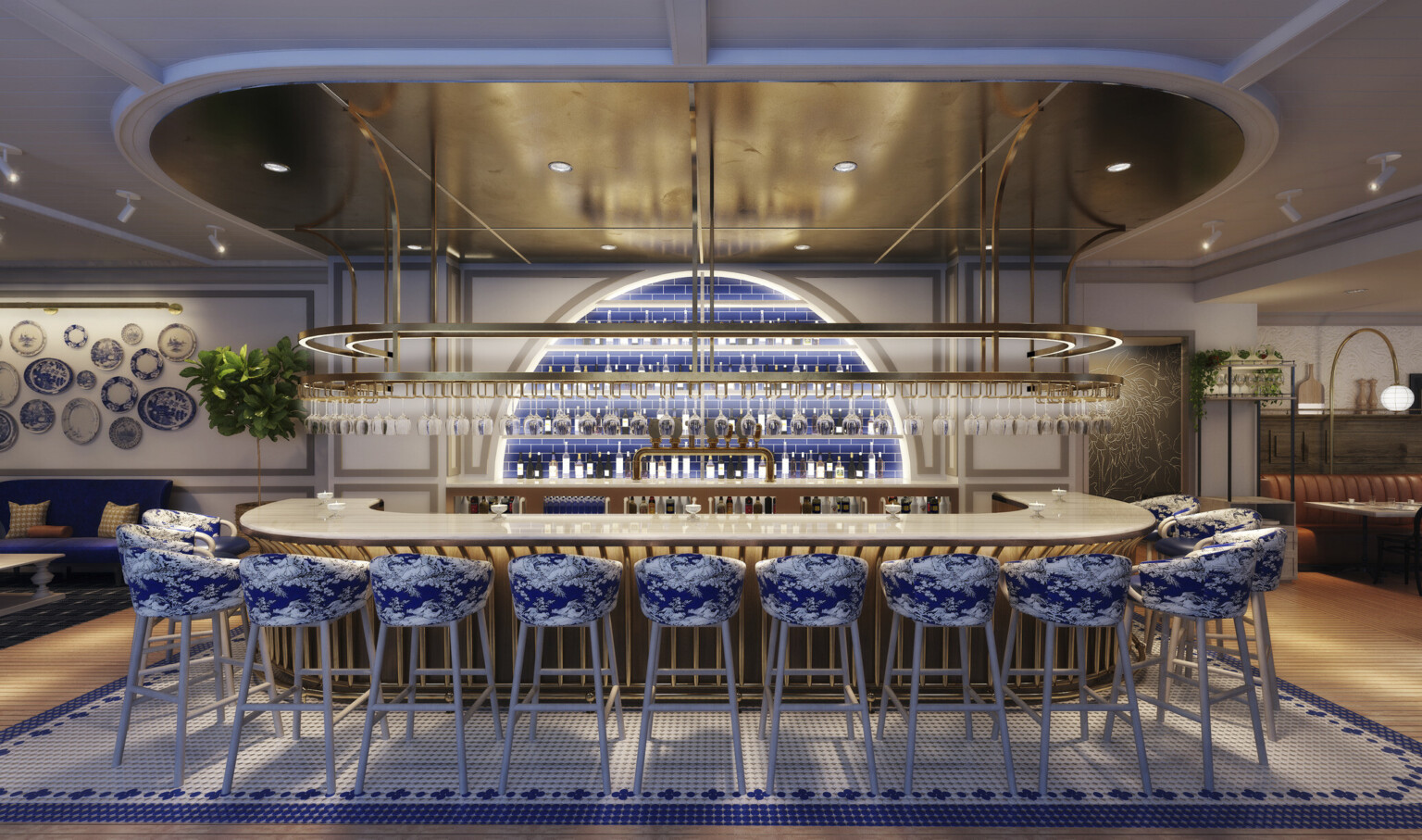 View facing bar with illuminated slat base. Arched recessed wall section with blue tile and shelves. Gold hanging glass rack