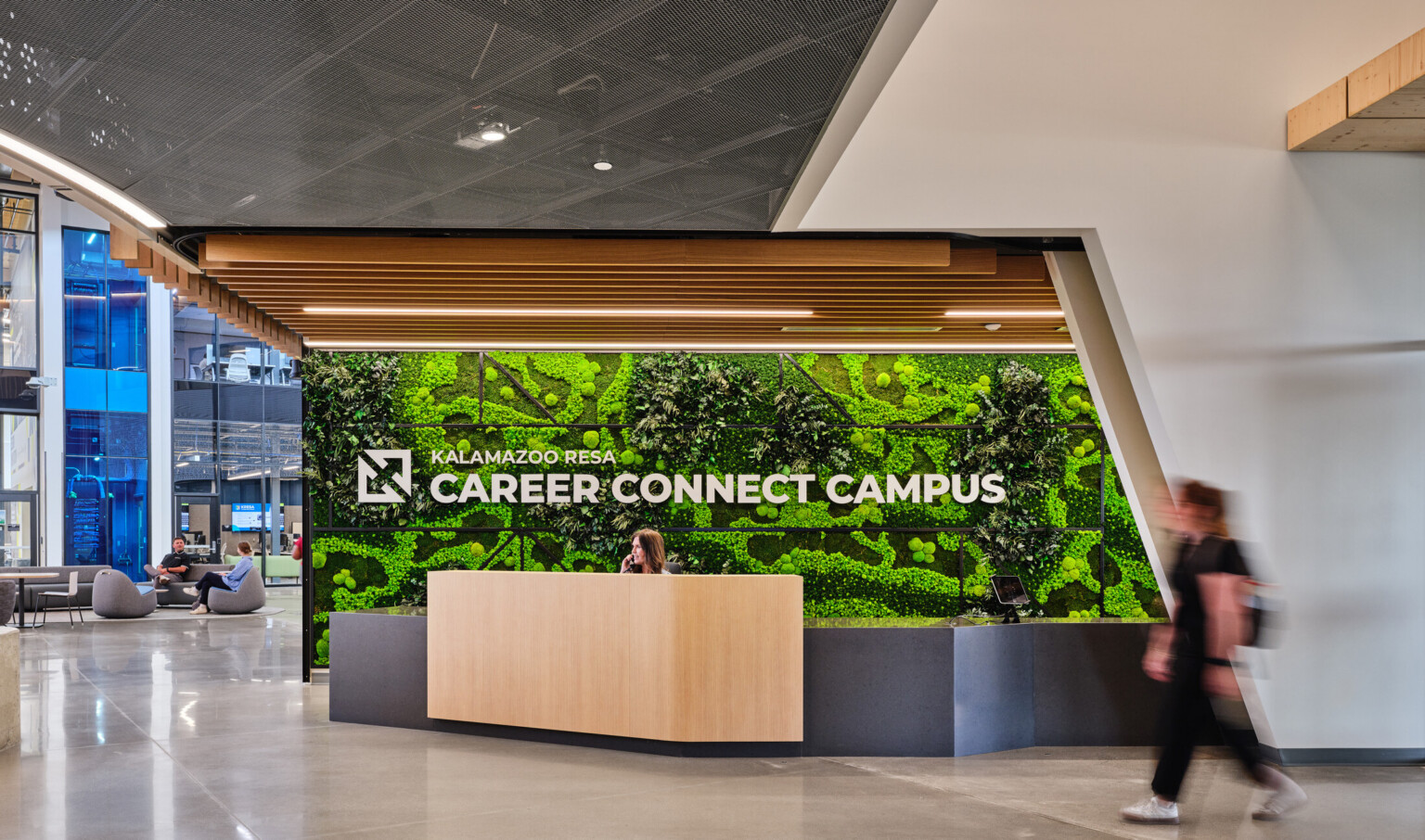 Kalamazoo RESA career connect campus entry desk featuring exposed wood structure, natural materials, and biophilic design elements