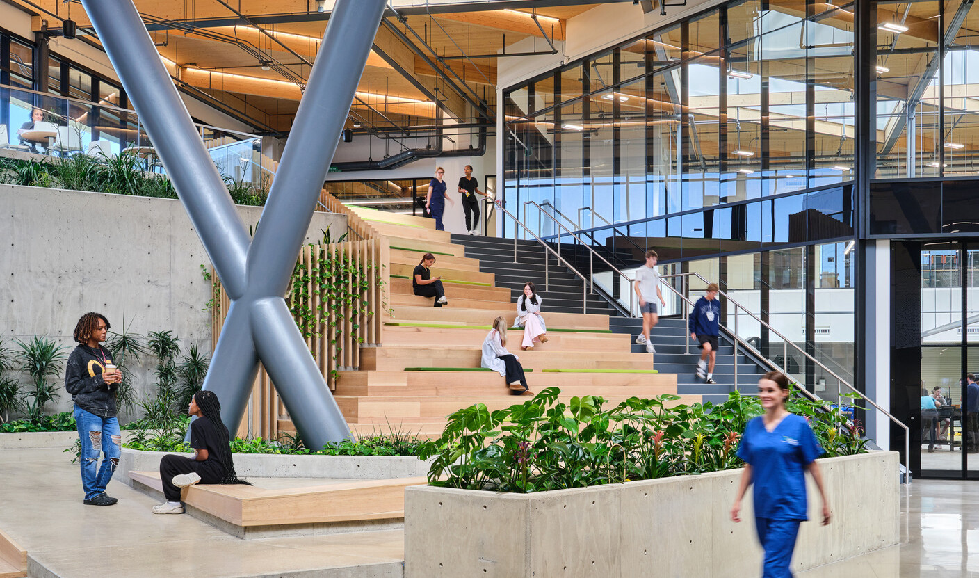 Kalamazoo RESA career technical education central open area featuring exposed wood structure, natural materials, and biophilic design elements; modular community seating