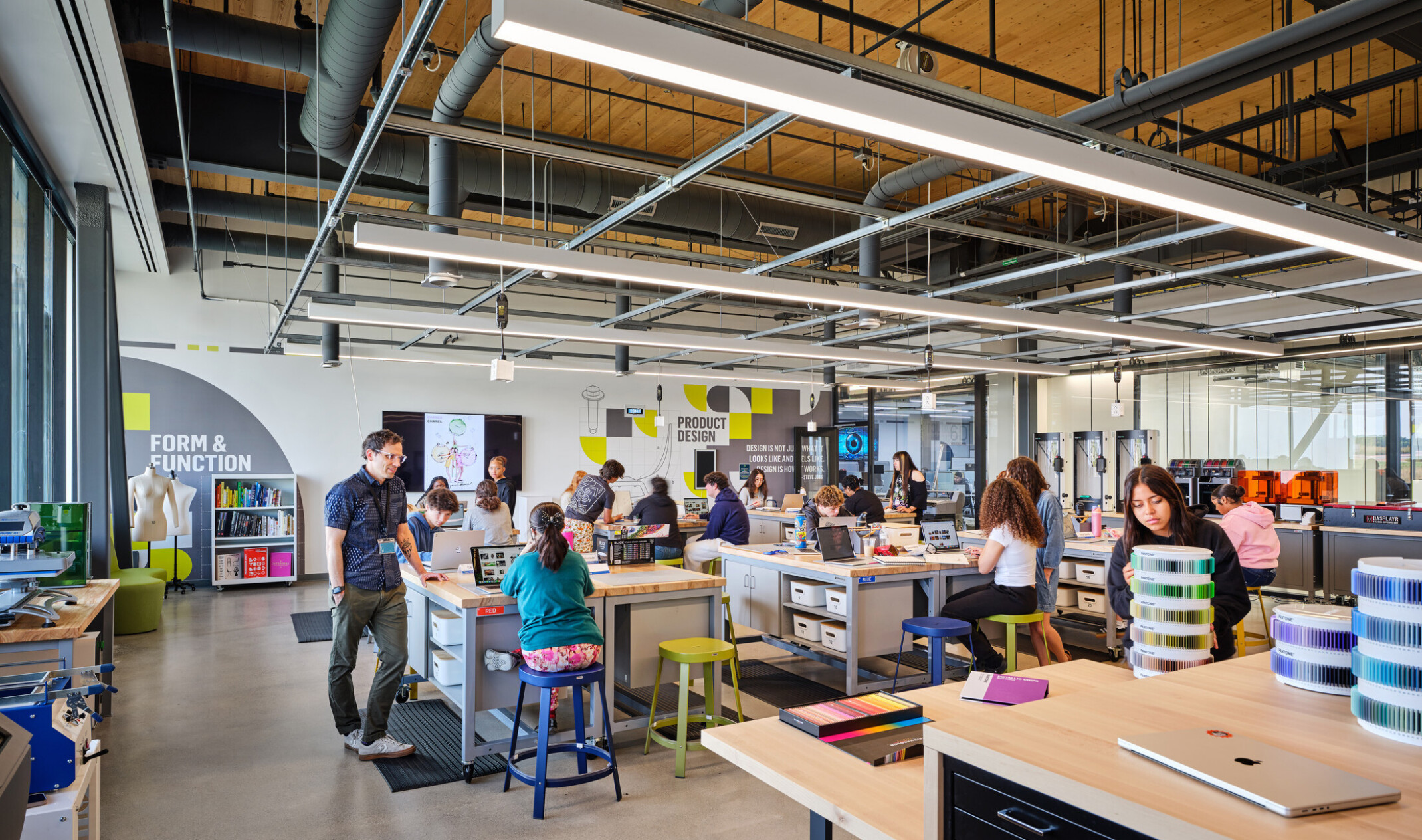 Technical classroom within Kalamazoo RESA career technical education building featuring exposed wood structure, natural materials, and biophilic design elements; students working at stations