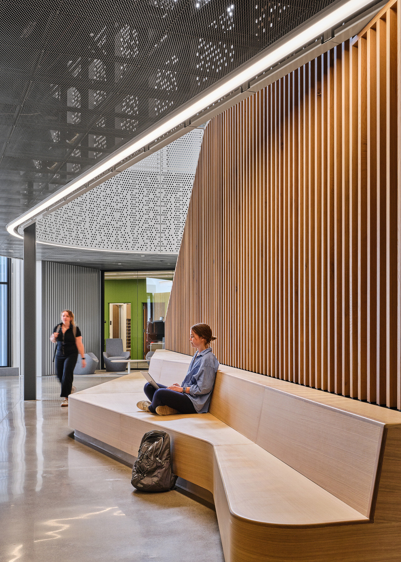 Kalamazoo RESA career technical education building featuring exposed wood structure, natural materials, and biophilic design elements; community bench seating in a hallway