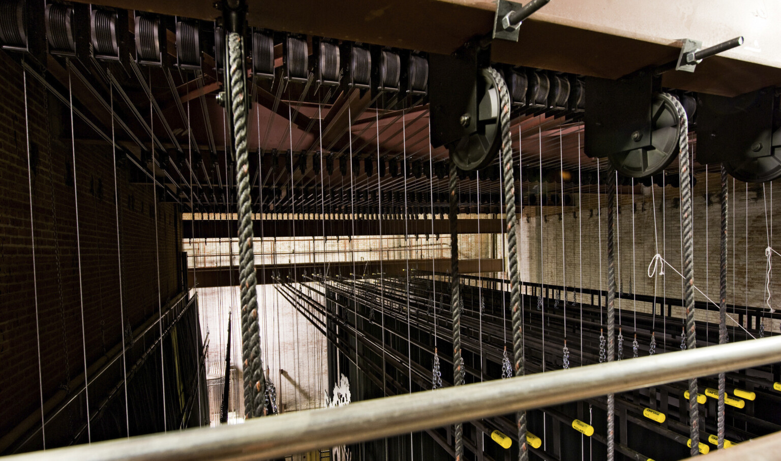 Closeup the lines of rope and cable in the rigging and fly system backstage