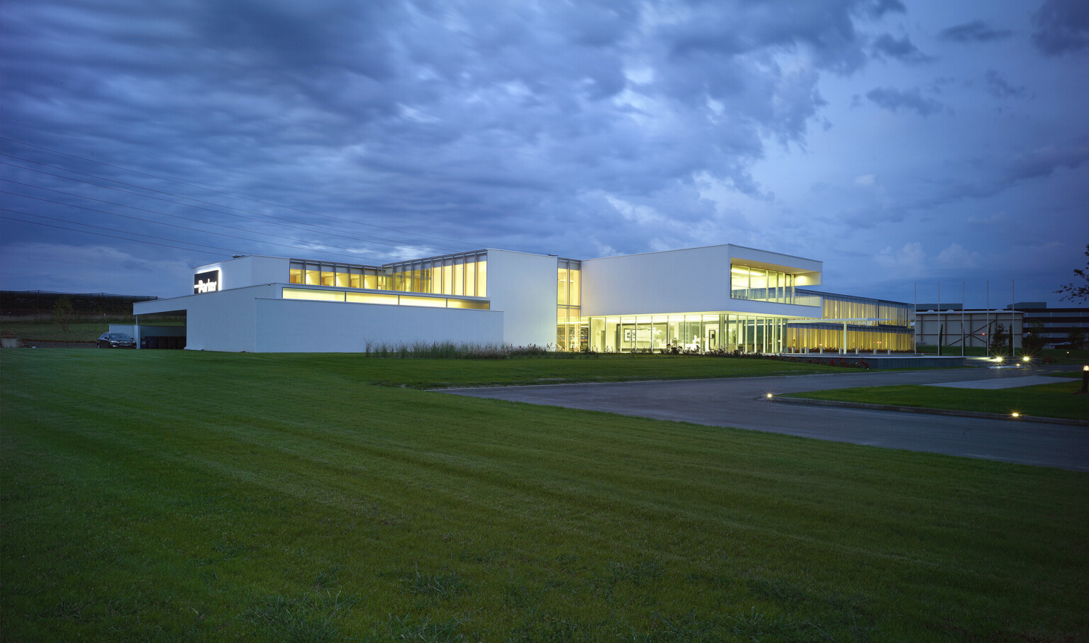 Parker Hannifin European Headquarters, a 2 story building with white wrapped facade around large floor to ceiling windows