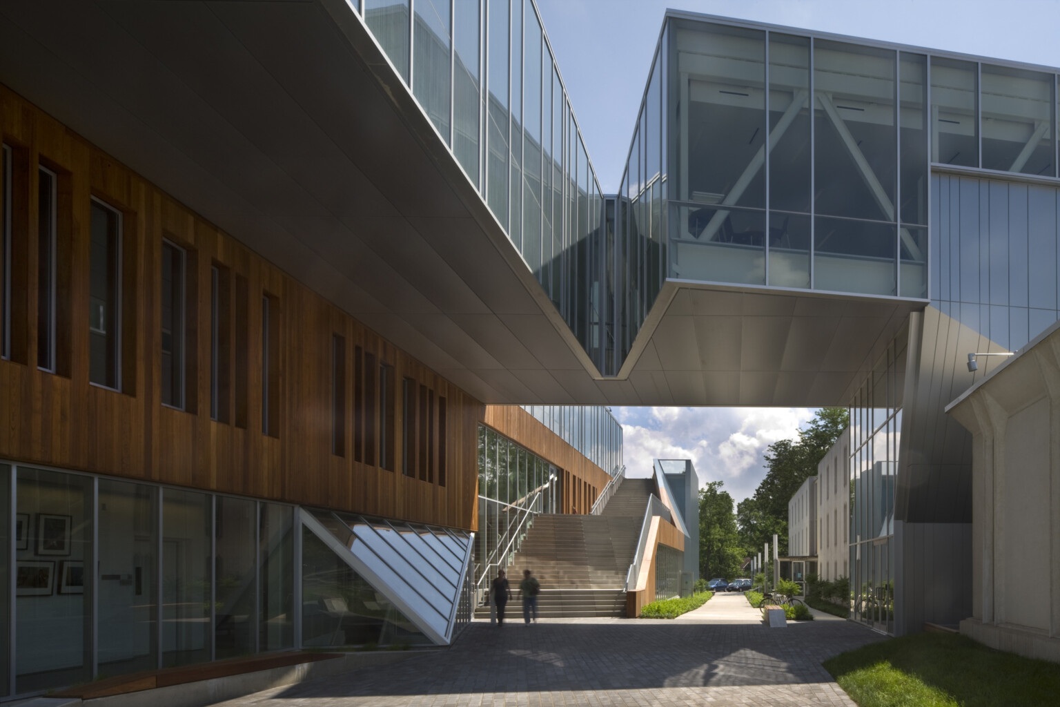 Partially covered walkway between buildings, building at left has first floor window walls below wood panels; dlr group design Partially covered walkway between buildings, building at left has first floor window walls below wood panels; dlr group design