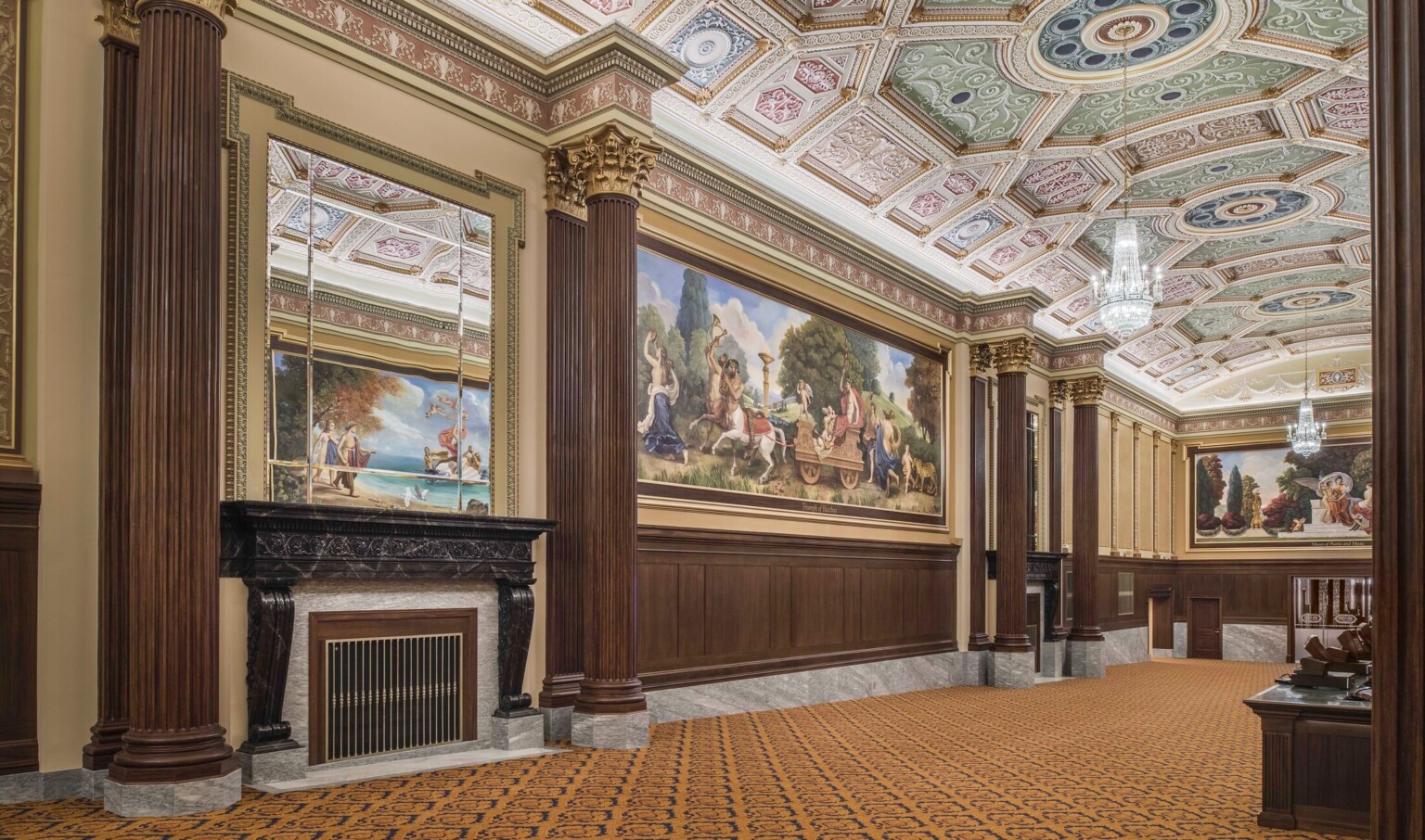carpeted hallway with corinthian columns and colorful ceiling frescoes and large scale wall murals