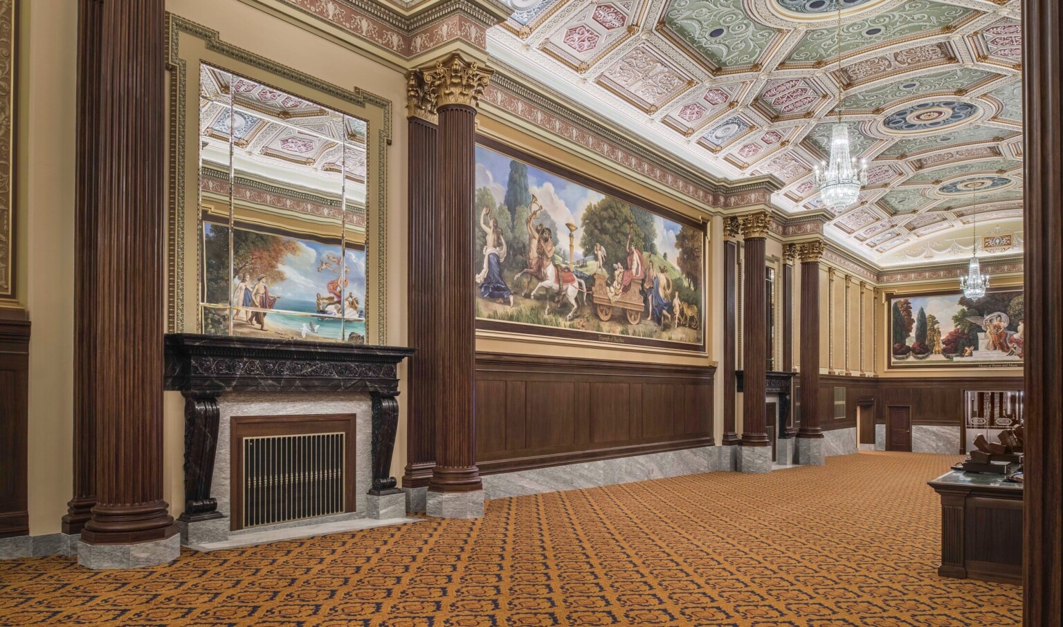 carpeted hallway with corinthian columns and colorful ceiling frescoes and large scale wall murals