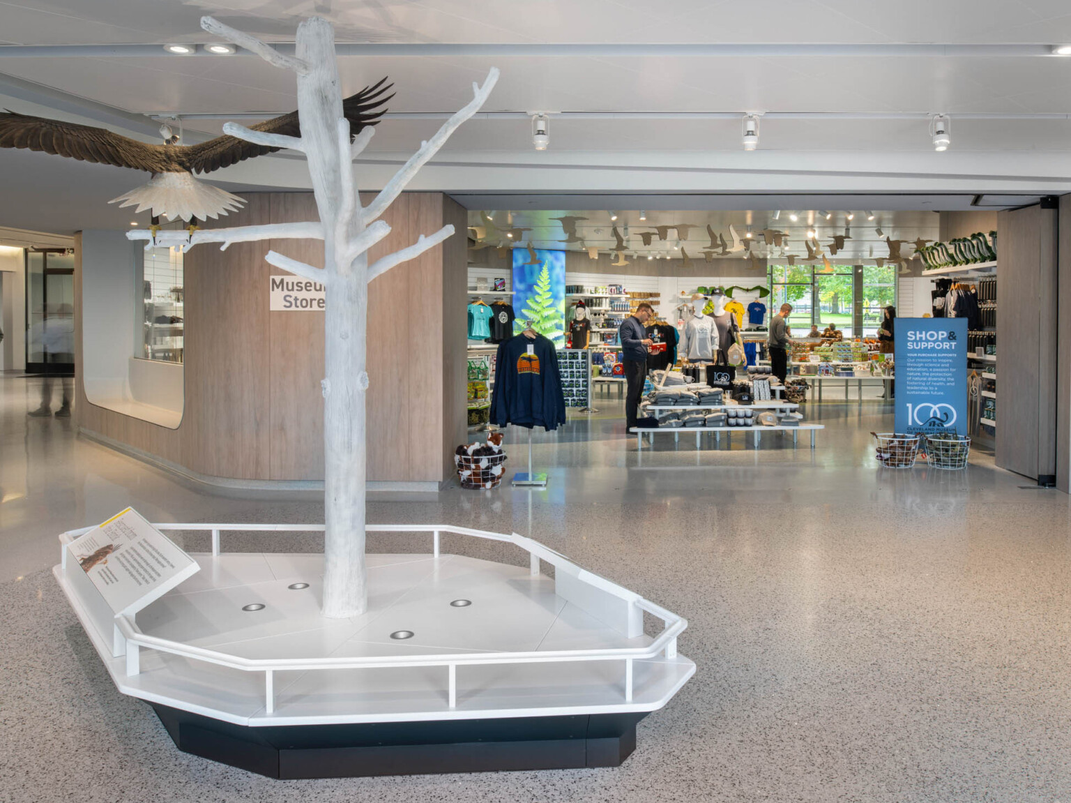 View of a gift shop with a tree sculpture with a large bird on a branch