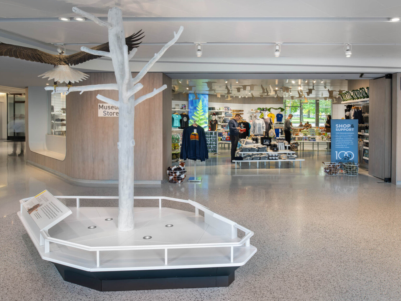 View of a gift shop with a tree sculpture with a large bird on a branch