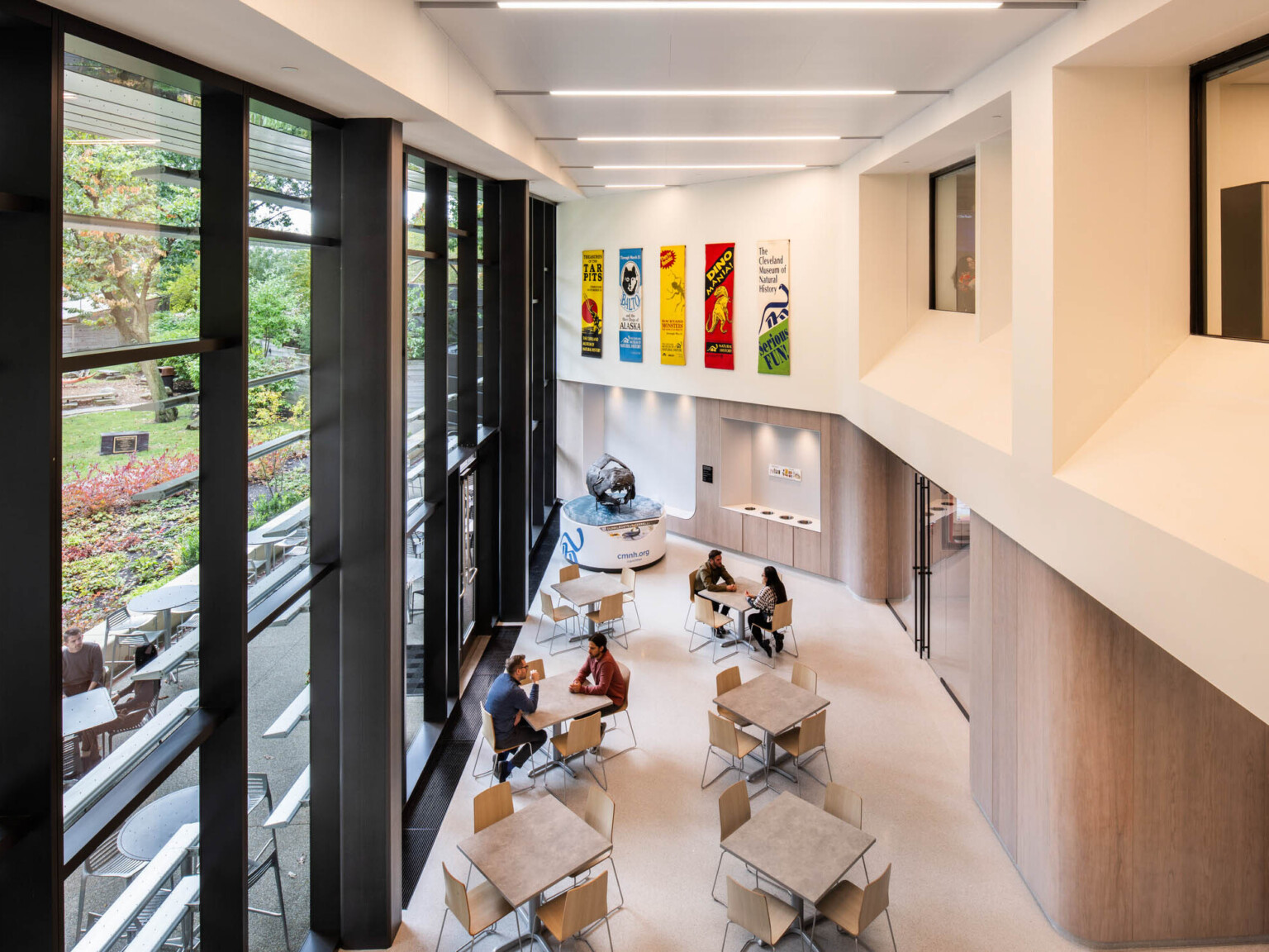 View of a double story seating area from above showing multiple tables with chairs