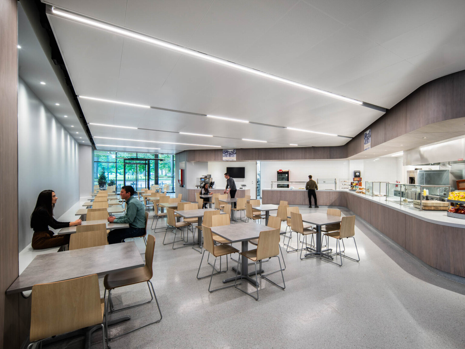 Museum cafeteria filled with tables and chairs with a lunch line