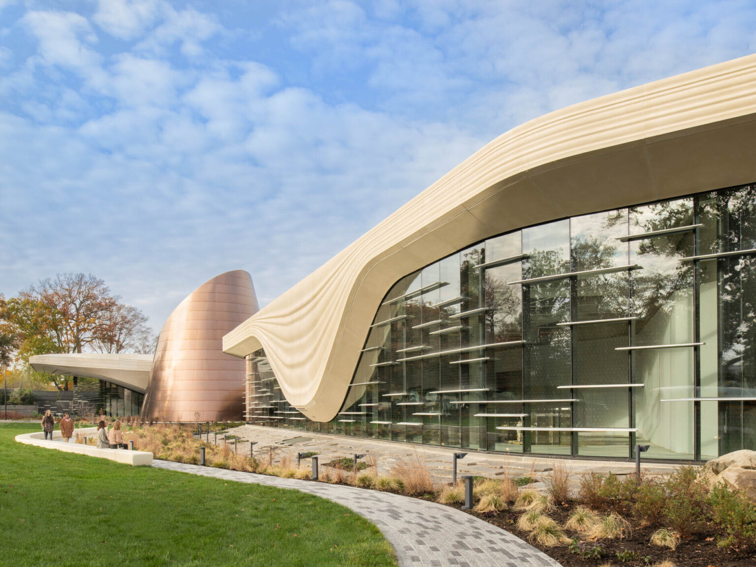 Exterior of the Cleveland Museum of Natural History showing lush grass and large windows