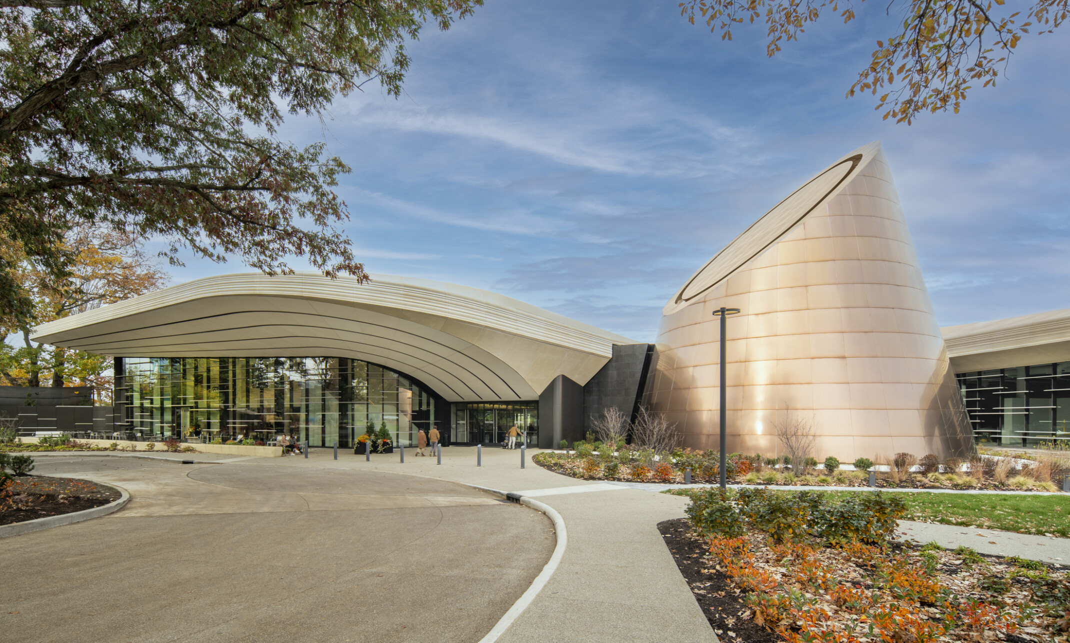 Modern building with a cone shaped tower surrounded by landscaping