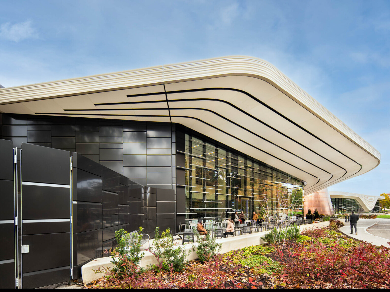 Exterior of the Cleveland Museum of Natural history showing a wall of windows with a white awning