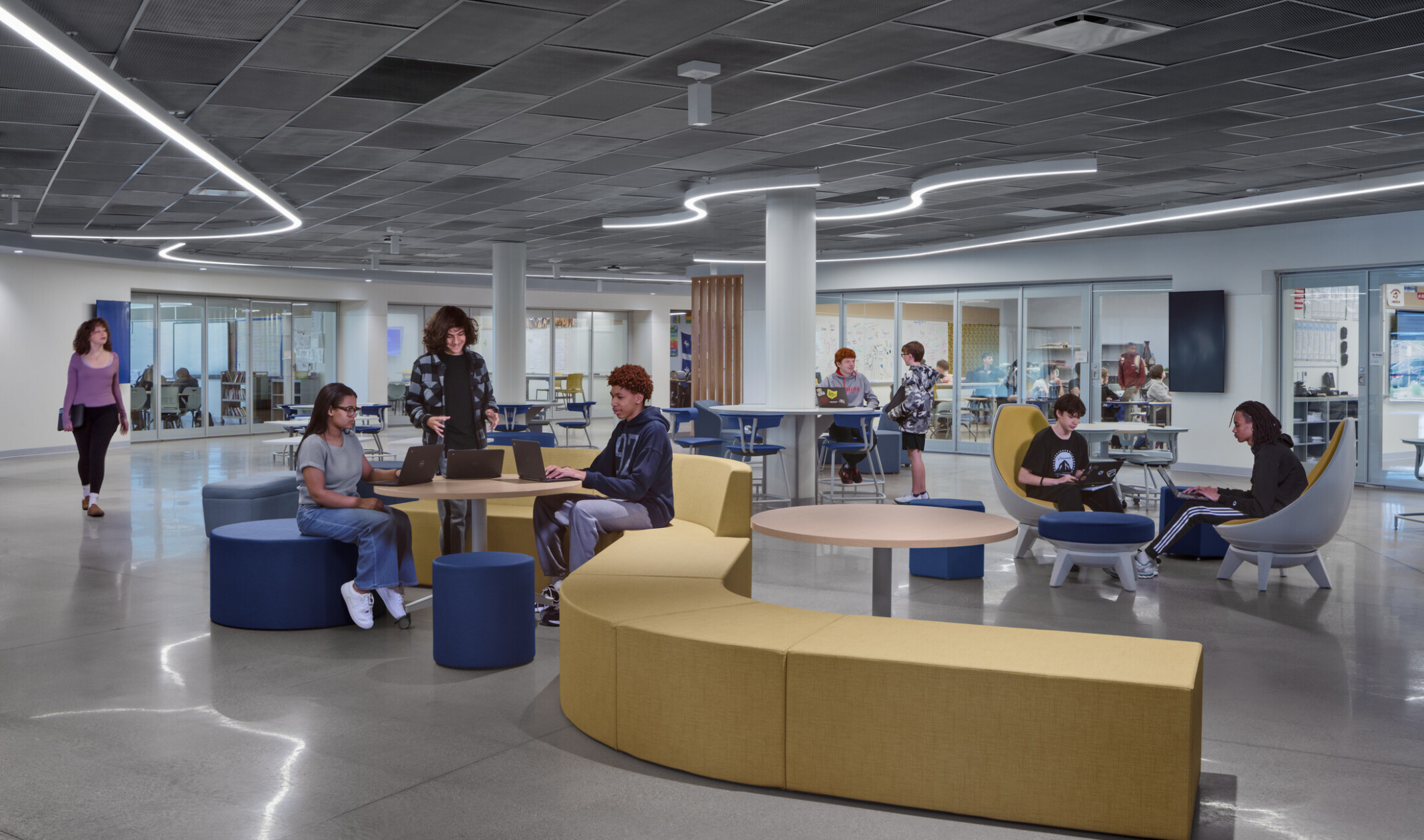 gathering area, public use in lincoln high school; varied seating with yellow and blue couches and chairs; career-focused, visible, open areas to celebrate learning