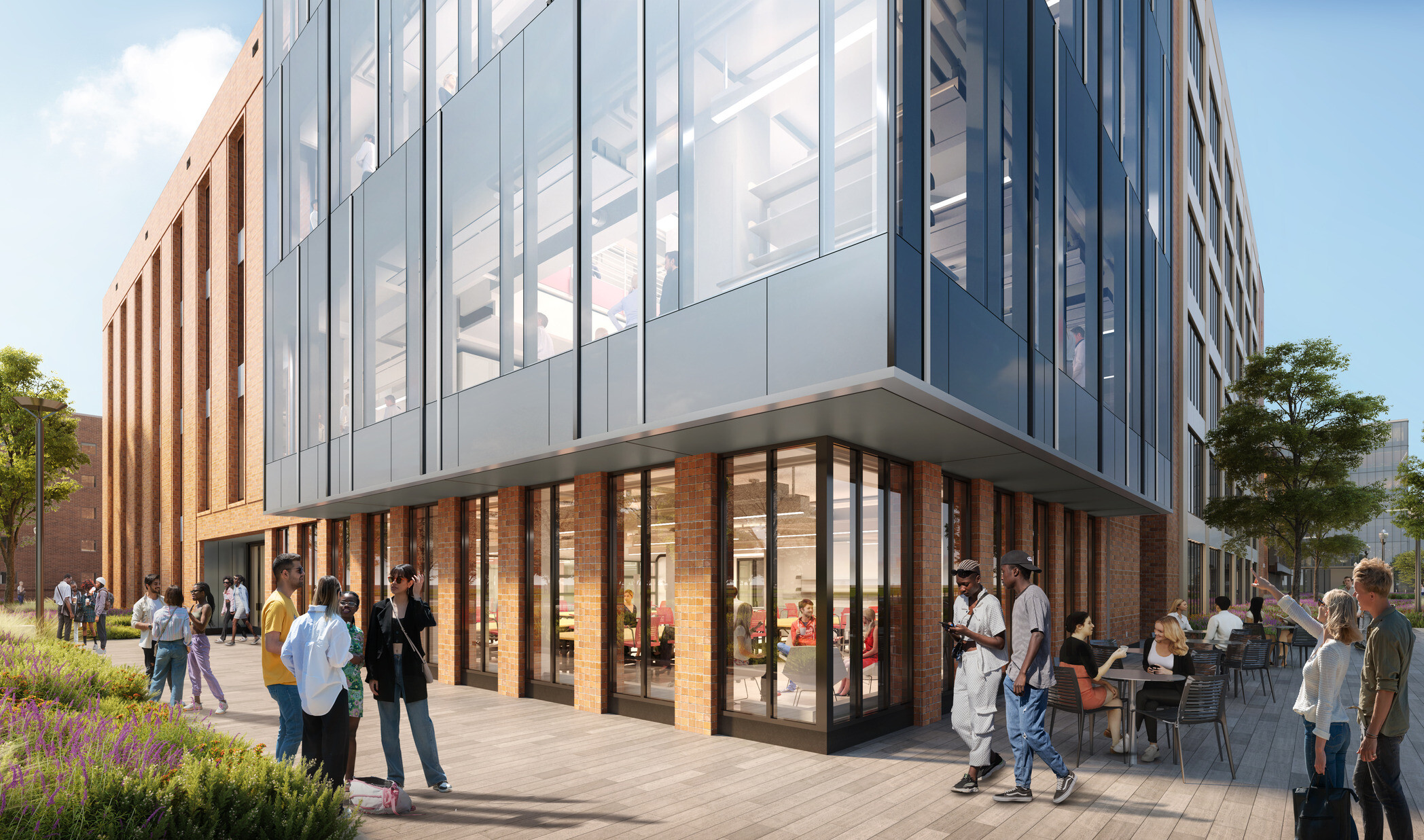 Multi story brick and glass wrapped facade building at corner view, transparent access to engineering stem facility for public