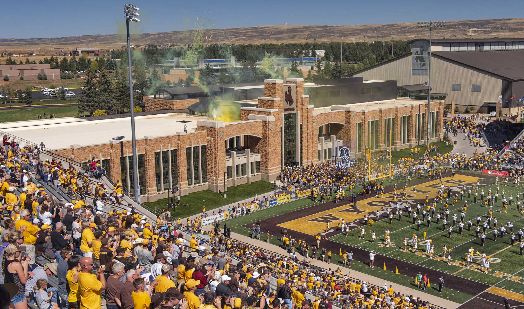 High Altitude Performance Center at the University of Wyoming seen from stands looking to stone building with yellow smoke