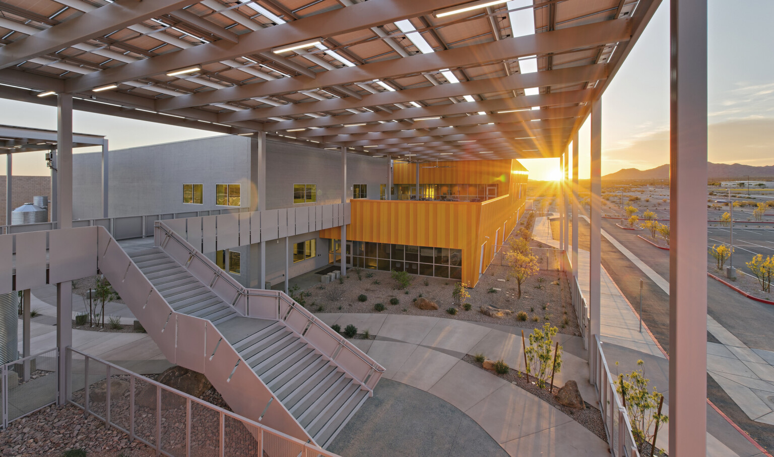 Western Maricopa Education Center (West-MEC) Southwest campus entrance. A 2 story grey and yellow building with solar canopy Western Maricopa Education Center (West-MEC) Southwest campus entrance. A 2 story grey and yellow building with solar canopy