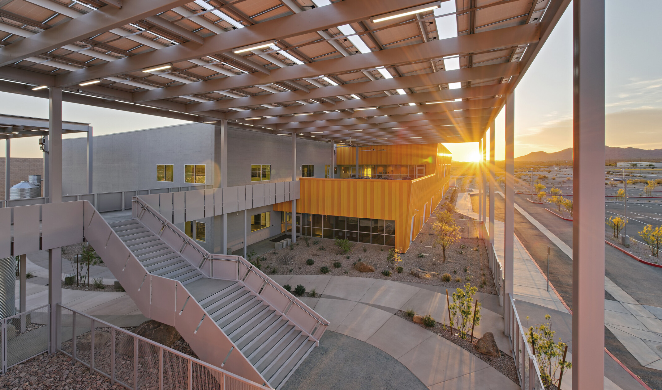 Western Maricopa Education Center (West-MEC) Southwest campus entrance. A 2 story grey and yellow building with solar canopy