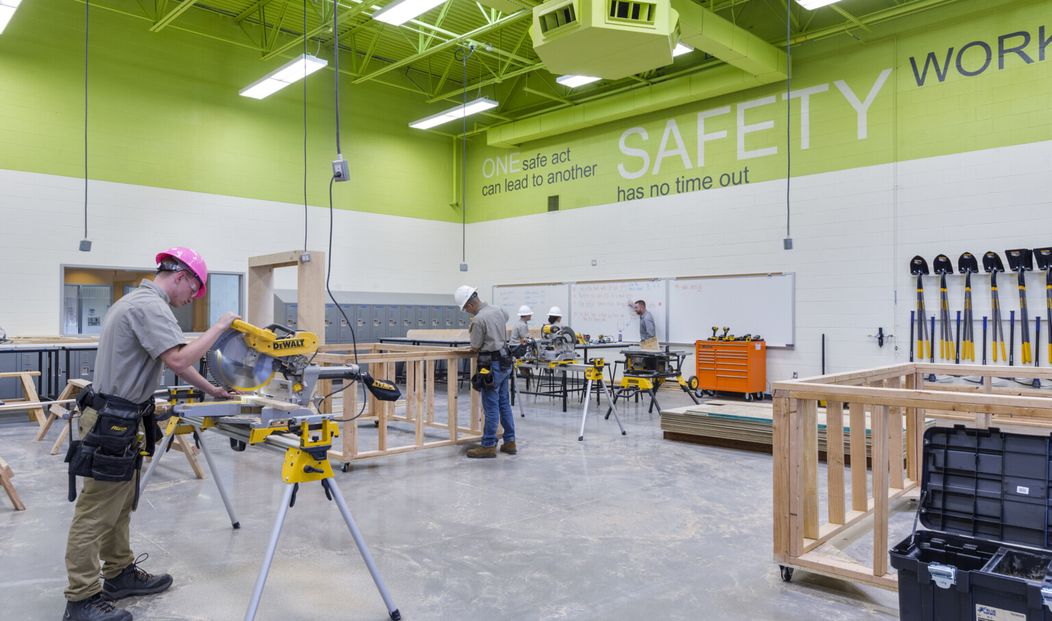 students in construction shop with green walls woodworking
