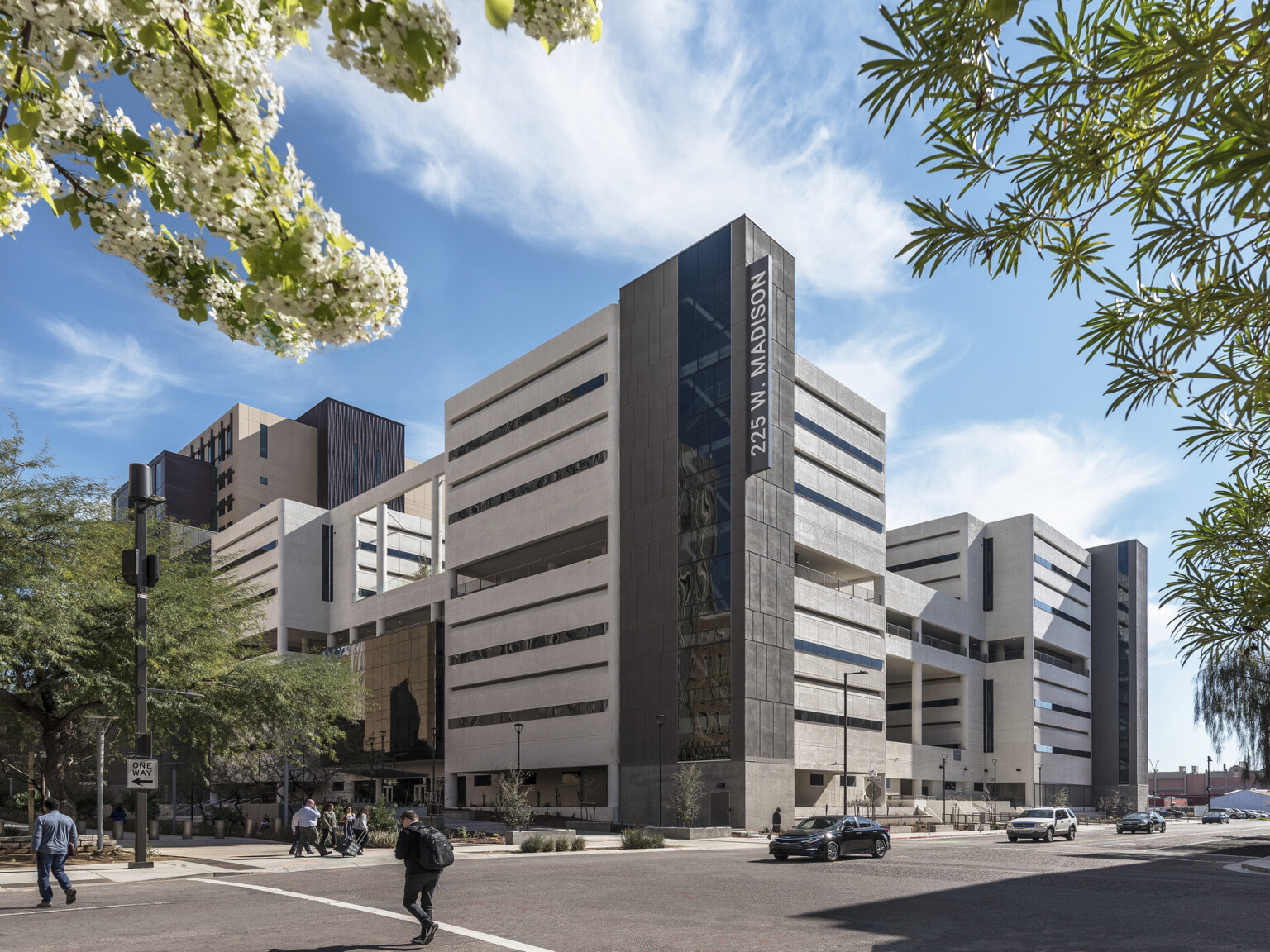 mid rise commercial office building at a street corner with active pedestrian and vehicular traffic