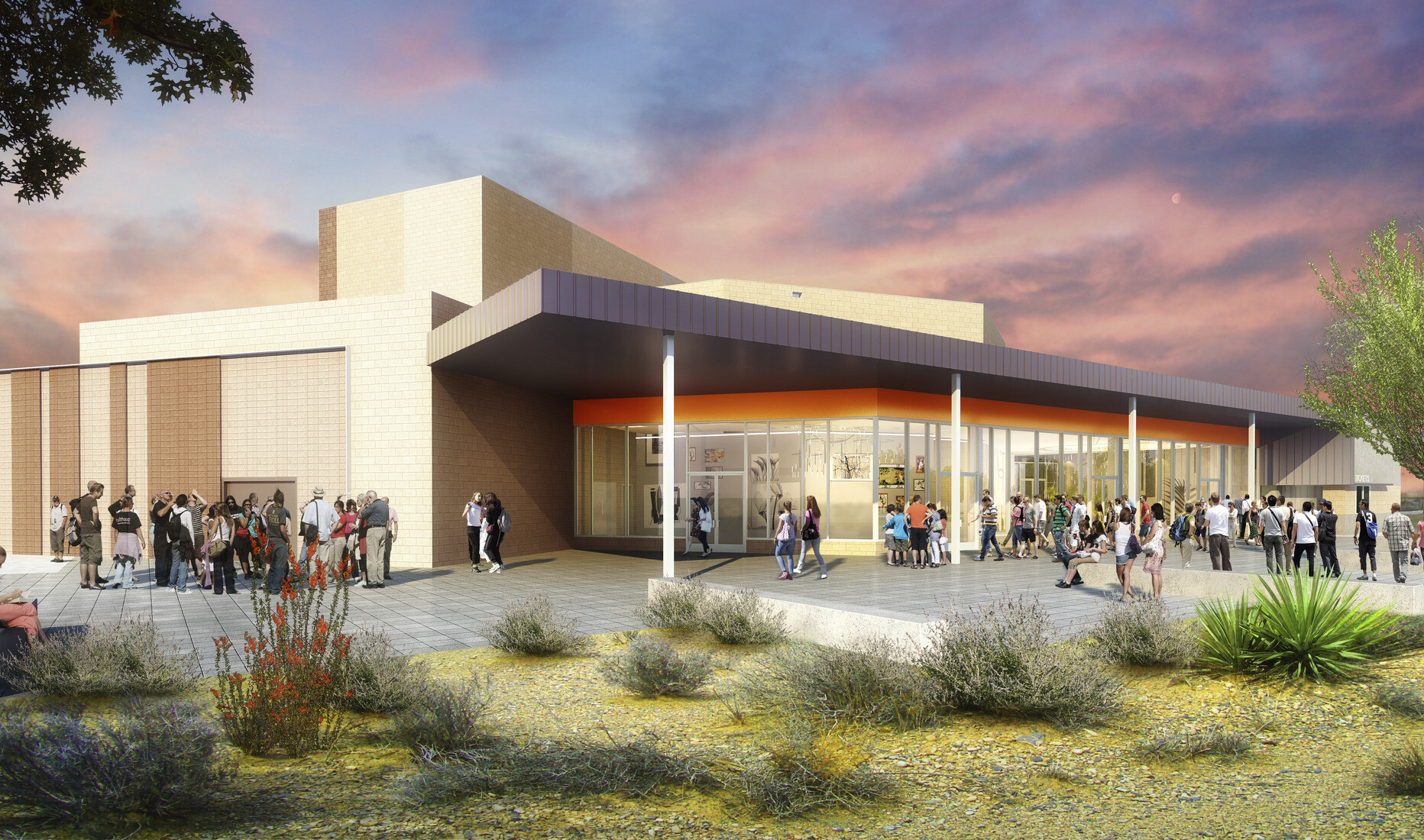 Exterior view of J.O. Combs High School Auditorium, orange accent over floor to ceiling window entry of beige building