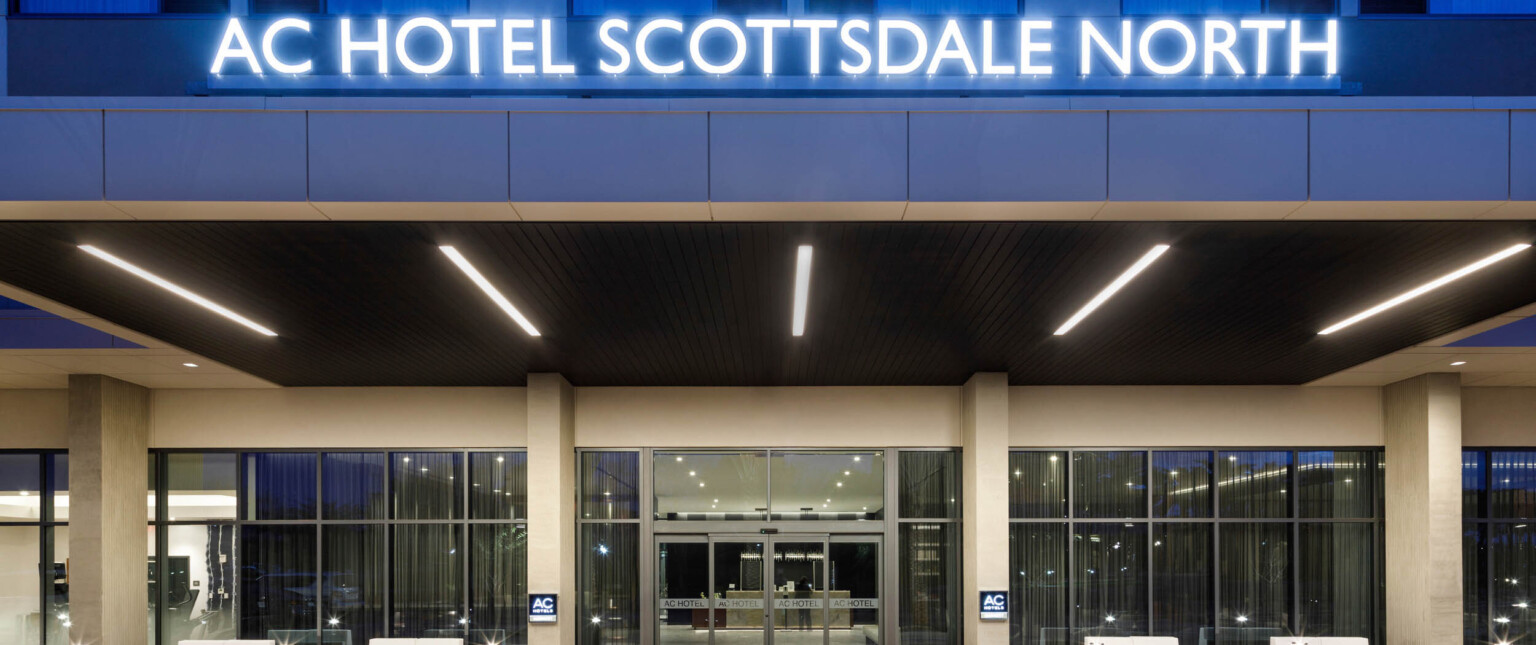entry to the AC Hotel Scottsdale North with blue neon lights following the Marriott brand architecture